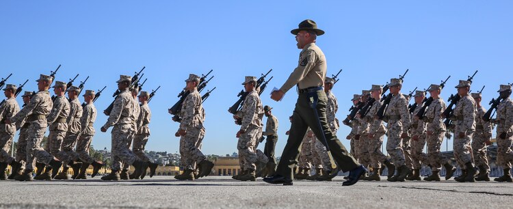 A drill instructor of Mike Company, 3rd Recruit Training Battalion, marches his recruits during Final Drill at Marine Corps Recruit Depot San Diego, Nov. 23. Final Drill is one of the last tests the recruits face before earning the title Marine. Today, all male recruits recruited from recruiting stations west of the Mississippi are trained at MCRD San Diego. The depot is responsible for training more than 16,000 recruits annually. Mike Company graduates recruit training Dec. 11.
