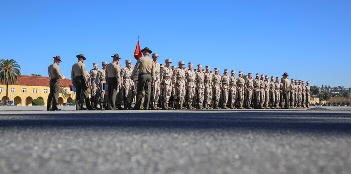 Recruits of Mike Company, 3rd Recruit Training Battalion, stand in formation waiting to begin Final Drill at Marine Corps Recruit Depot San Diego, Nov. 23. Recruits were graded on the precision of each movement and small detail such as excessive movement that would cost the platoon points off their score. Today, all male recruits recruited from recruiting stations west of the Mississippi are trained at MCRD San Diego. The depot is responsible for training more than 16,000 recruits annually. Mike Company graduates recruit training Dec. 11.