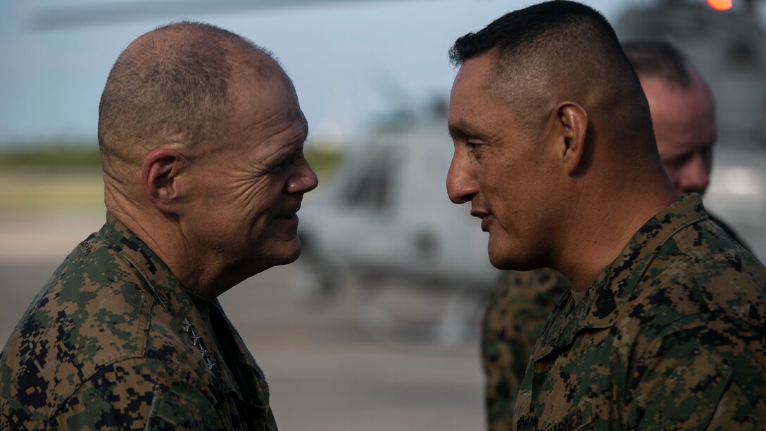 The 37th Commandant of the Marine Corps, Gen. Robert B. Neller, speaks with Sgt. Maj. Mario A. Marquez during a Nov. 23 visit to Marine Corps Air Station Futenma, Okinawa. The CMC and Sgt. Maj. of the Marine Corps Ronald L. Green visited service members with III Marine Expeditionary Force, the “tip of the spear,” in the Asia-Pacific region by travelling around and speaking with forward deployed Marines across the installations that comprise Marine Corps Base Camp Smedley D. Butler, Okinawa, Japan. The Marine Corps must be maintained as a crisis response force and a force in readiness, to include the ability for Marines to remain forward deployed and ready to fight and win. Marquez is the sergeant major with 1st Marine Aircraft Wing.