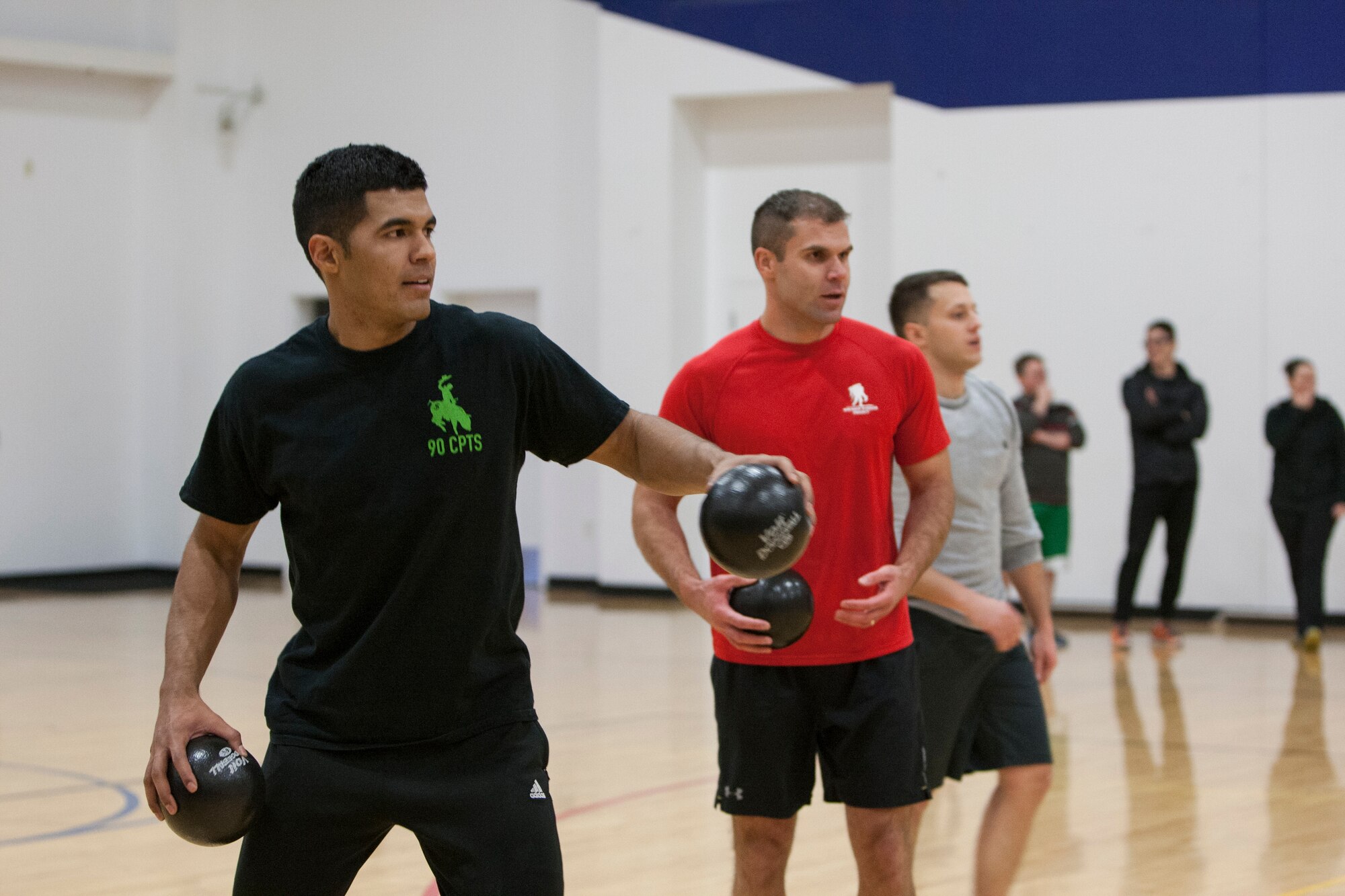 Justin Smith, Cory Galaz and Stephen Kendrick, 90th Comptroller Squadron, stand ready to compete during a dodgeball tournament at the Freedom Hall Fitness Center on F.E. Warren Air Force Base, Nov. 20, 2015. More than 100 base members participated in the tournament. (U.S. Air Force photo by Lan Kim)
