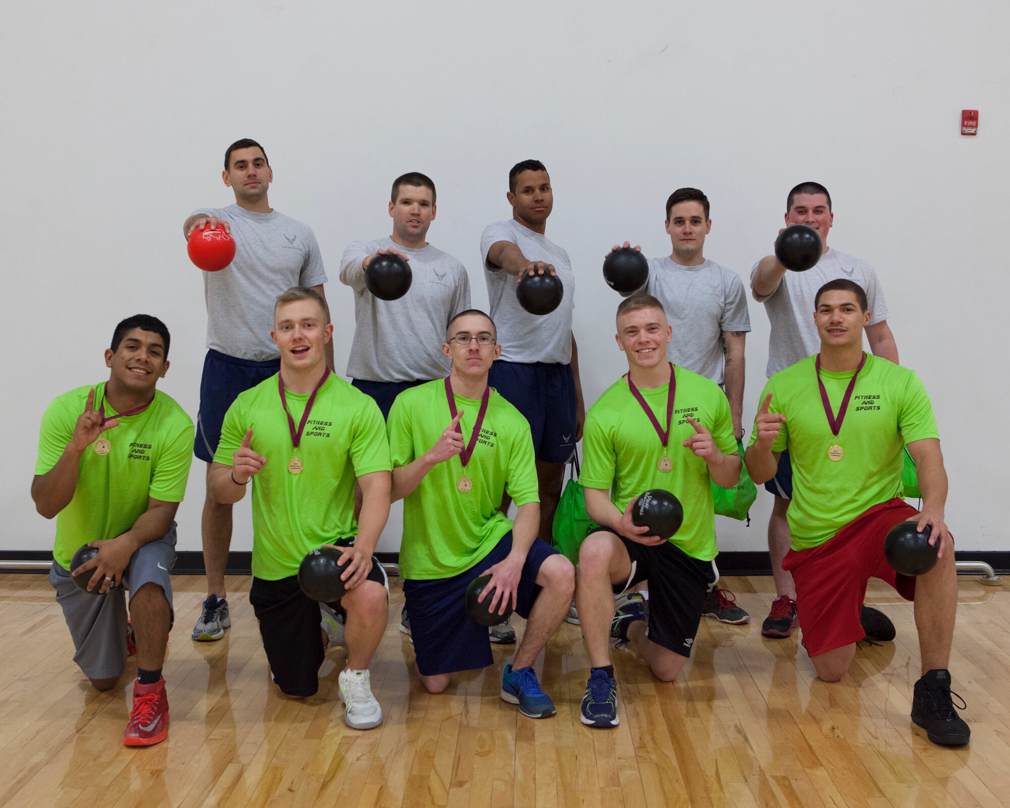 The teams representing first and second place, pose for a group photo after the completion of a dodgeball tournament at the Freedom Hall Fitness Center on F.E. Warren Air Force Base, Nov. 20, 2015. Airmen from 90th Force Support Squadron fitness center staff comprised the winning team and students from Airmen Leadership Class 16-B took second place. (U.S. Air Force photo by Lan Kim)
