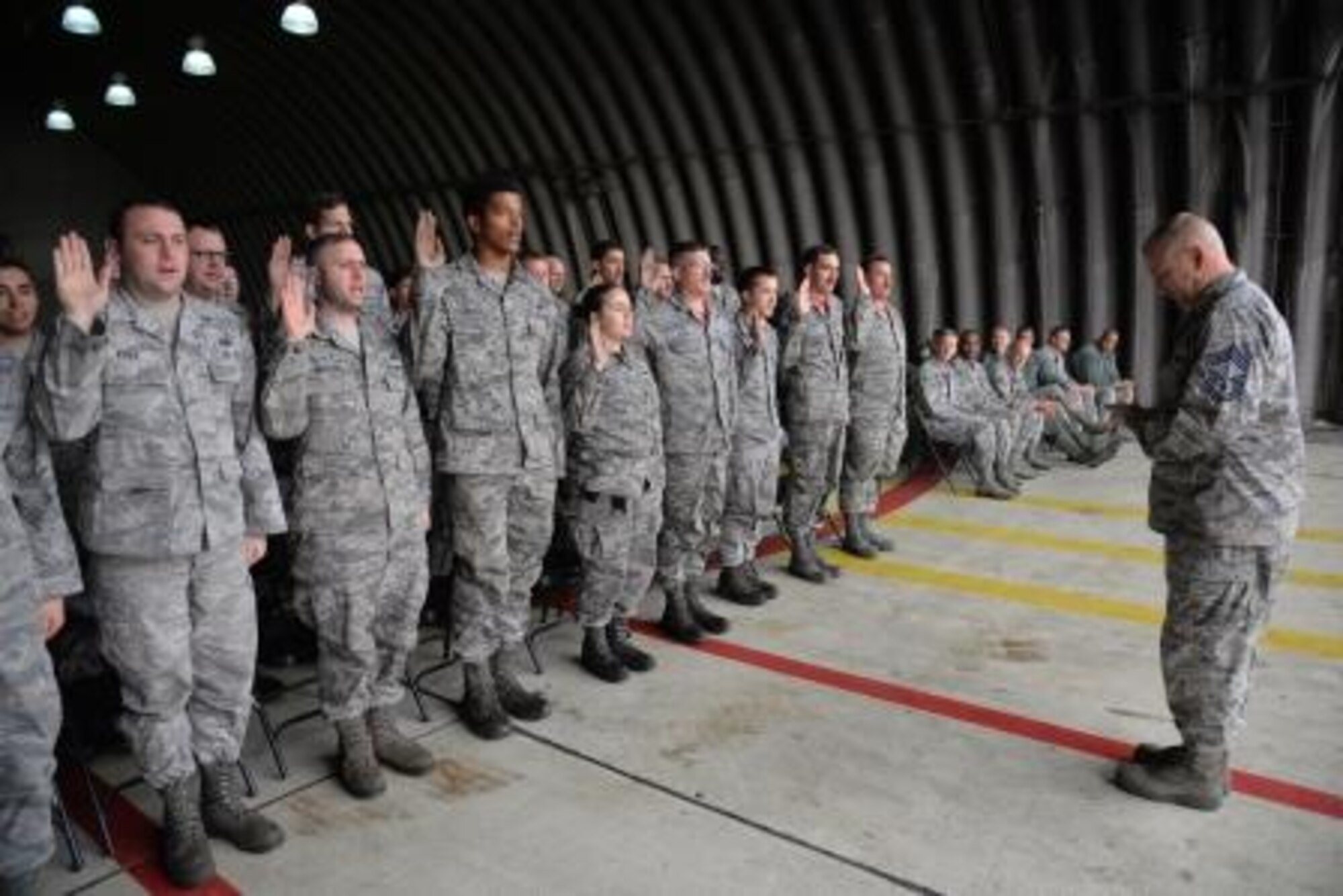 Maintainers assigned to the 36th Aircraft Maintenance Unit recite the oath of the Dedicated Crew Chief Nov. 20, 2015, at Osan Air Base, Republic of Korea. Twenty-seven maintenance Airmen received the title Dedicated Crew Chief, or DCC, at a ceremony recognizing them as the maintenance experts on their respective aircraft. (U.S. Air Force photo/Staff Sgt. Benjamin Sutton)