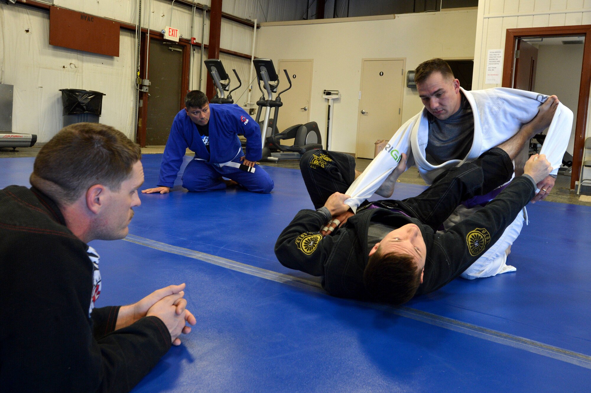 A Combatives House jiu-jitsu instructor performs ground techniques on a student during training at Shaw Air Force Base, S.C., Nov. 14, 2015. The classes are open to all skill levels and groups and squadrons are encouraged to use the facility during its open hours to perform group physical training. (U.S. Air Force photo by Senior Airman Diana M. Cossaboom)