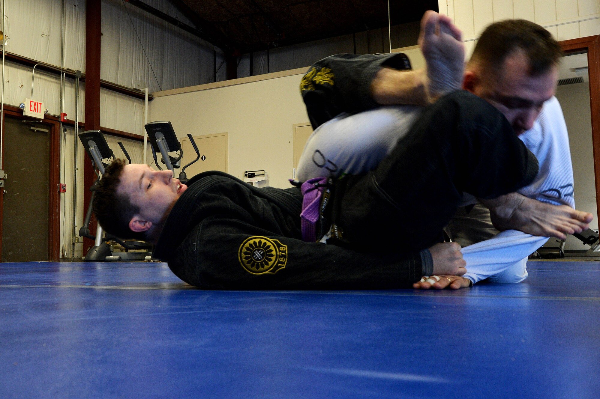 A Combatives House jiu-jitsu instructor performs ground techniques on a student during training at Shaw Air Force Base, S.C., Nov. 14, 2015. Classes and equipment are open to anyone who can get on base except for the Army Level I and II Combatives training and boxing which are open to military members only. (U.S. Air Force photo by Senior Airman Diana M. Cossaboom)