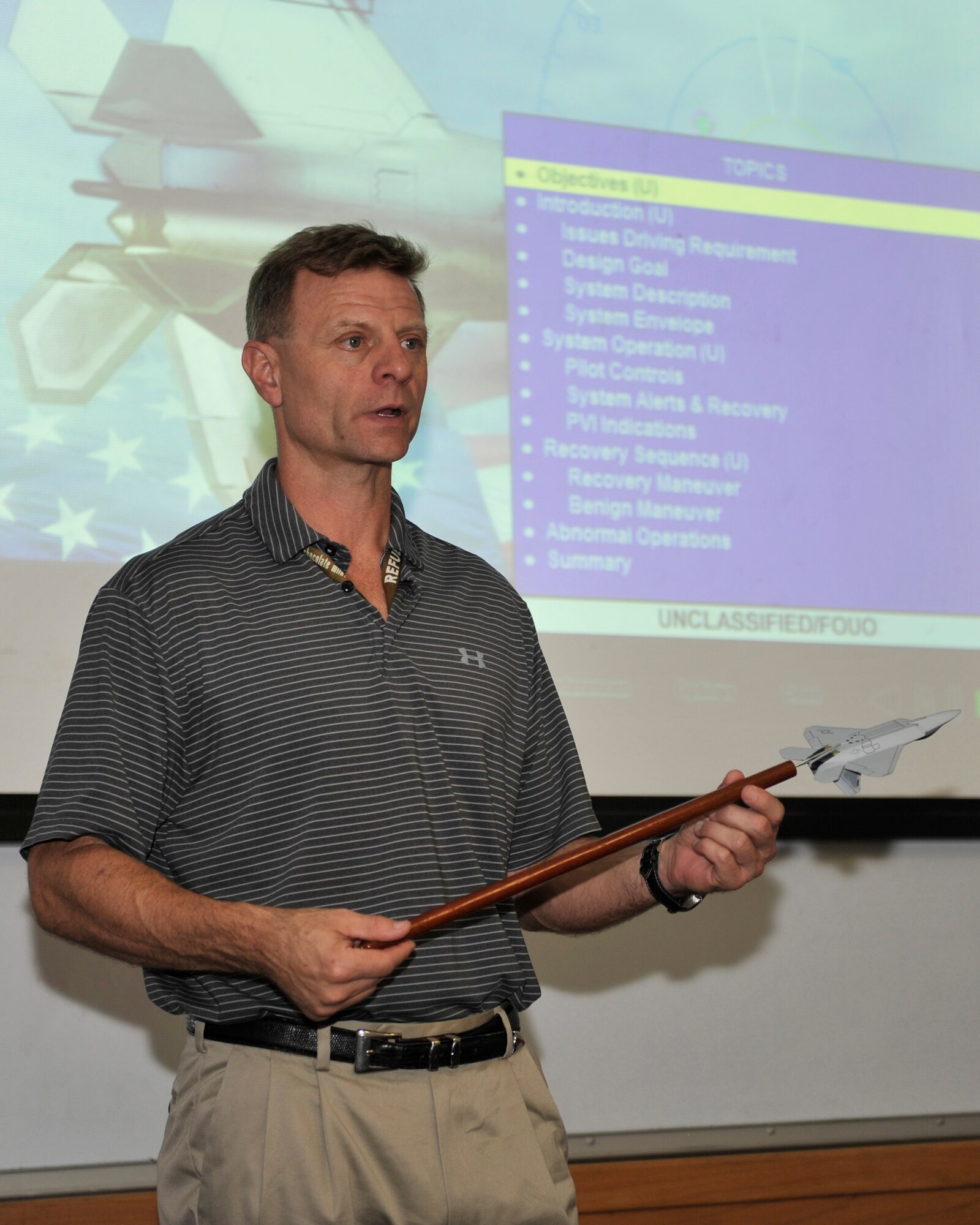Wade Causey, 325th Training Support Squadron civilian simulator instructor, goes over some course material for F-22 Raptor academic training Nov. 17 at Tyndall Air Force Base. Causey was retraining simulator instructors and pilots for the F-22 Raptor. (U.S. Air Force photo by Senior Airman Sergio A. Gamboa/Released)