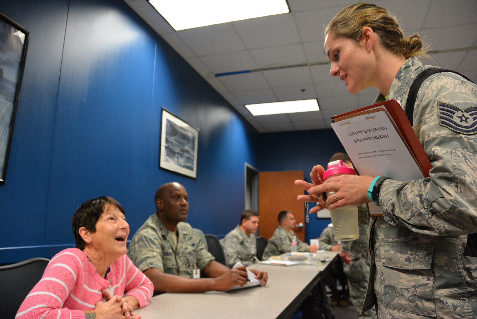 Jacqueline Falkner, 507th Air Refueling Wing Director of Psychological Operations, speaks to a Reservist in a deployment processing line during an exercise on the November unit training assembly weekend at Tinker Air Force Base, Okla. Prior to mobilizing, Air Force members must travel through a processing line of various agencies on base, obtaining signatures by representatives who ensure the Airmen have all required documents and supplies needed to deploy. (U.S. Air Force photo/Tech. Sgt. Charles Taylor)