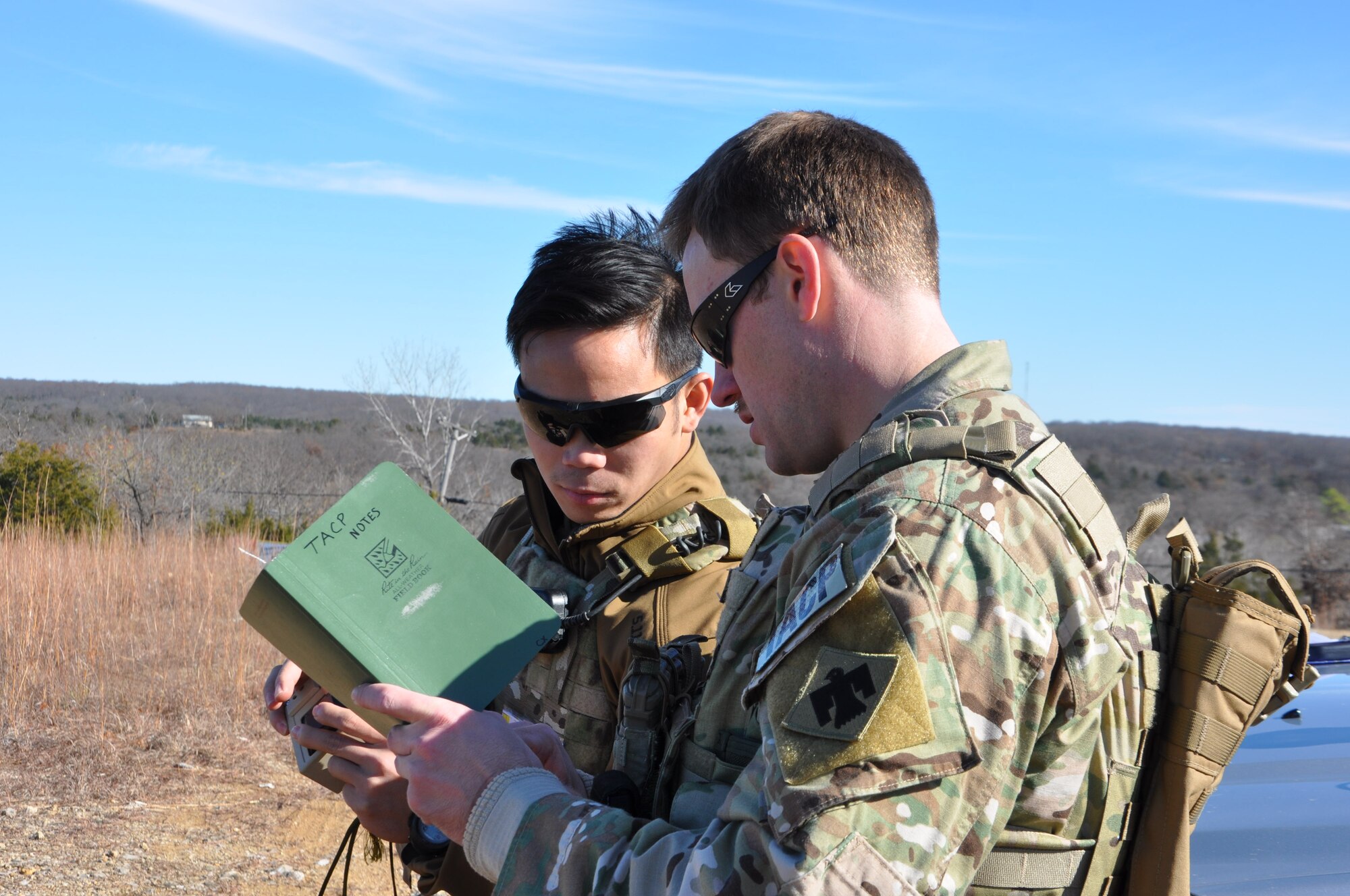 Airman 1st Class Kavin Tayaq, a student JTAC, and Capt. Christopher Cadieux, a student TACP with the 146th Airlift Wing, California Air National Guard, discuss techniques while preparing for a simulated air strike as part of their field training exercise south of Warsaw, Missouri on 19 November. Cadieux is a former soldier, but moved into tactical air control, which he describes as the “best of both worlds” between the Army and Air Force. Both students called in simulated air strikes working with A-10 Thunderbolt II aircraft from the 442d Fighter Wing in scenarios similar to what they would experience on a real-world deployment. (U.S. Air Force photo/ Technical Sgt. Emily F. Alley)
