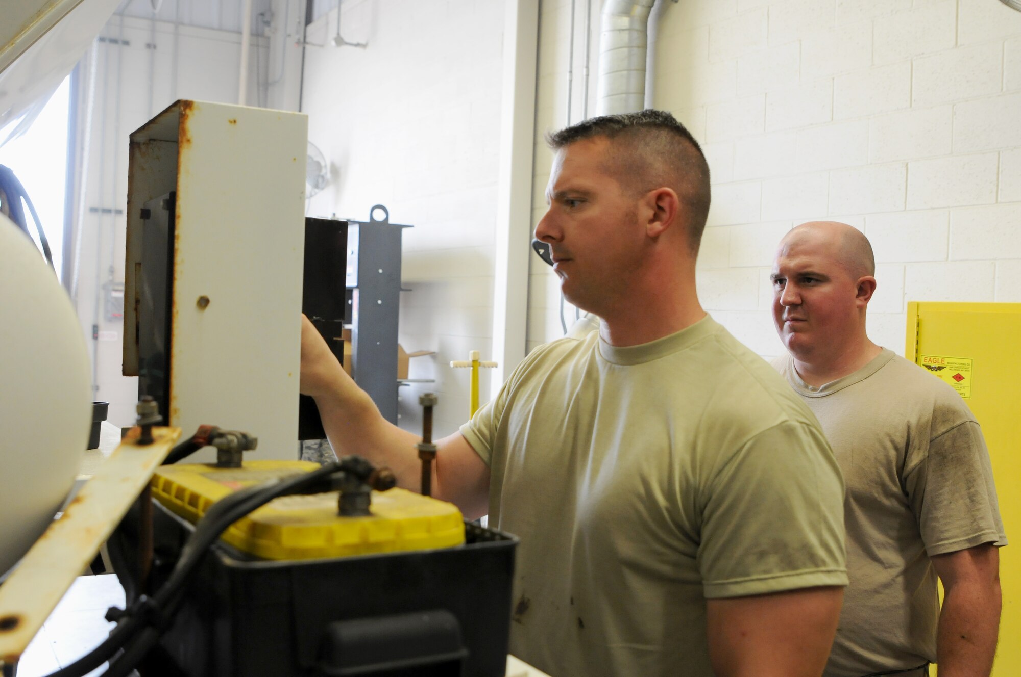 Tech. Sgt. Christopher Corbit, vehicle mechanic, and Senior Airman Aaron Russell, vehicle mechanic, operate on a Zim mixer Oct. 7, 2015, at Ebbing Air National Guard Base, Fort Smith, Ark. Airmen within Vehicle Maintenance handle all maintenance concerns for registered vehicles and technical support for ex-registered vehicles. (U.S. Air National Guard photo by Senior Airman Cody Martin/Released)