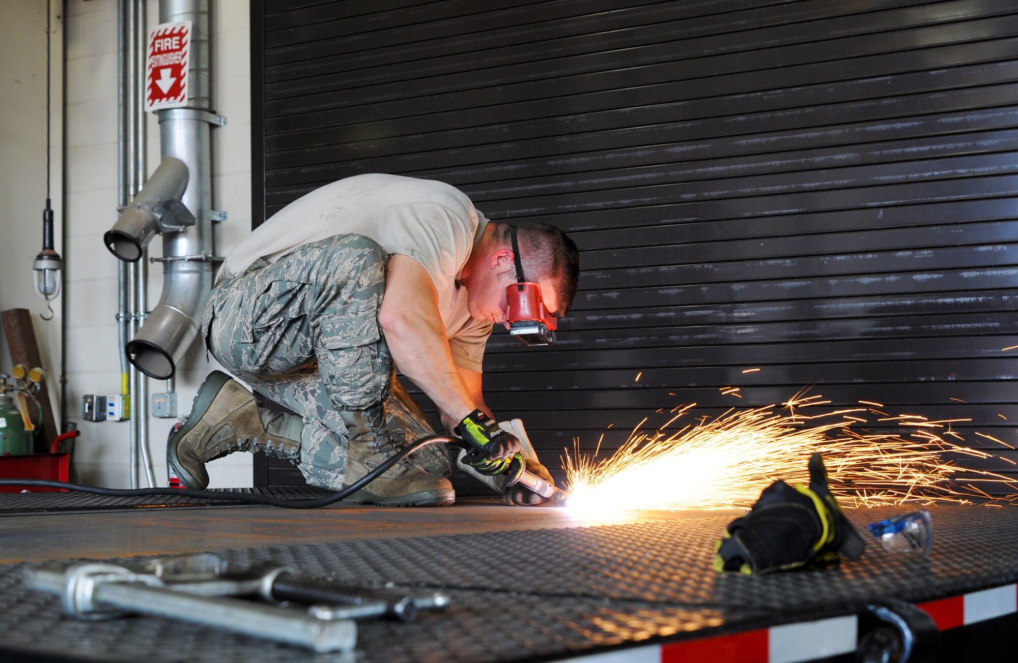 Tech. Sgt. Christopher Corbit, vehicle mechanic, uses a plasma cutter at Ebbing Air National Guard Base, Fort Smith, Ark., to remove eyelets Sept. 1, 2015. Airmen within Vehicle Maintenance handle all maintenance concerns for registered vehicles and technical support for ex-registered vehicles. (U.S. Air National Guard photo by Senior Airman Cody Martin/Released)