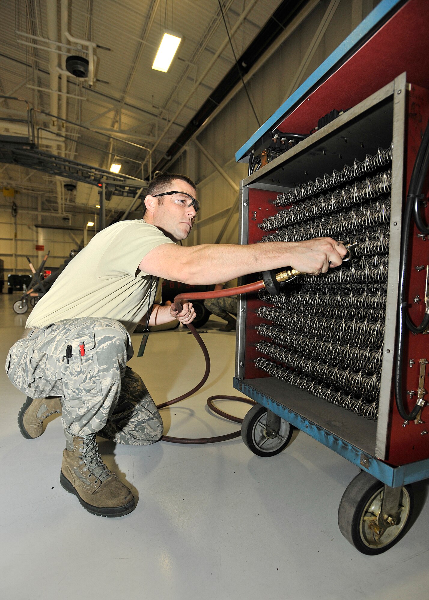 Tech. Sgt. James Queen, 319th Operations Support Squadron aerospace ground equipment flight chief, cleans out a load bank for a semi-annual inspection on Grand Forks Air Force Base, North Dakota, Nov. 23, 2015. The Clarksburg, West Virginia, native was named Warrior of the Week for the fourth week in November. (U.S. Air Force photo/Senior Airman Xavier Navarro/Released)