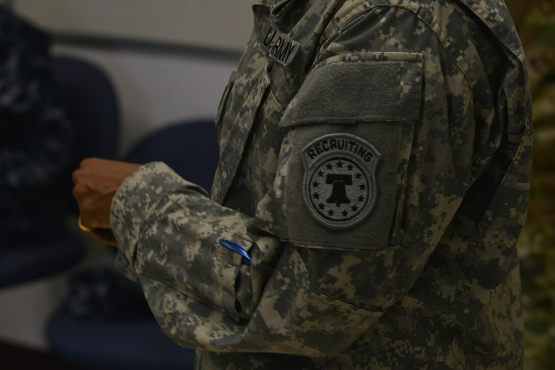 U.S. Army Chief Warrant Officer 4 Crystal Davis, a recruiter with U.S. Army Special Operations Recruiting Battalion (Airborne), goes over applying for the warrant officer program during the education and career fair at Fort Eustis, Va., Nov. 18, 2015. Davis briefed on what enlisted fields transfer into warrant officer jobs ranging from intelligence, mechanics, logistics, aviation and more. (U.S. Air Force photo by Staff Sgt. Natasha Stannard)  