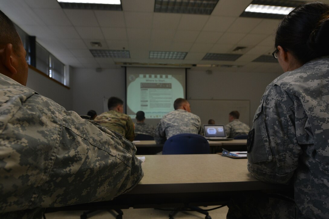 Alan Fiorello, an academic outreach manager with the University of Virginia, goes over the university’s programs and resources with U.S. Army Master Sgt. Lloyd Scott, a career counselor with U.S. Army Training and Doctrine Command, at Fort Eustis, Va., Nov. 18, 2015.  Fiorello represented one of the many schools and programs at the education and career fair held in accordance with American Education Week. (U.S. Air Force photo by Staff Sgt. Natasha Stannard)  