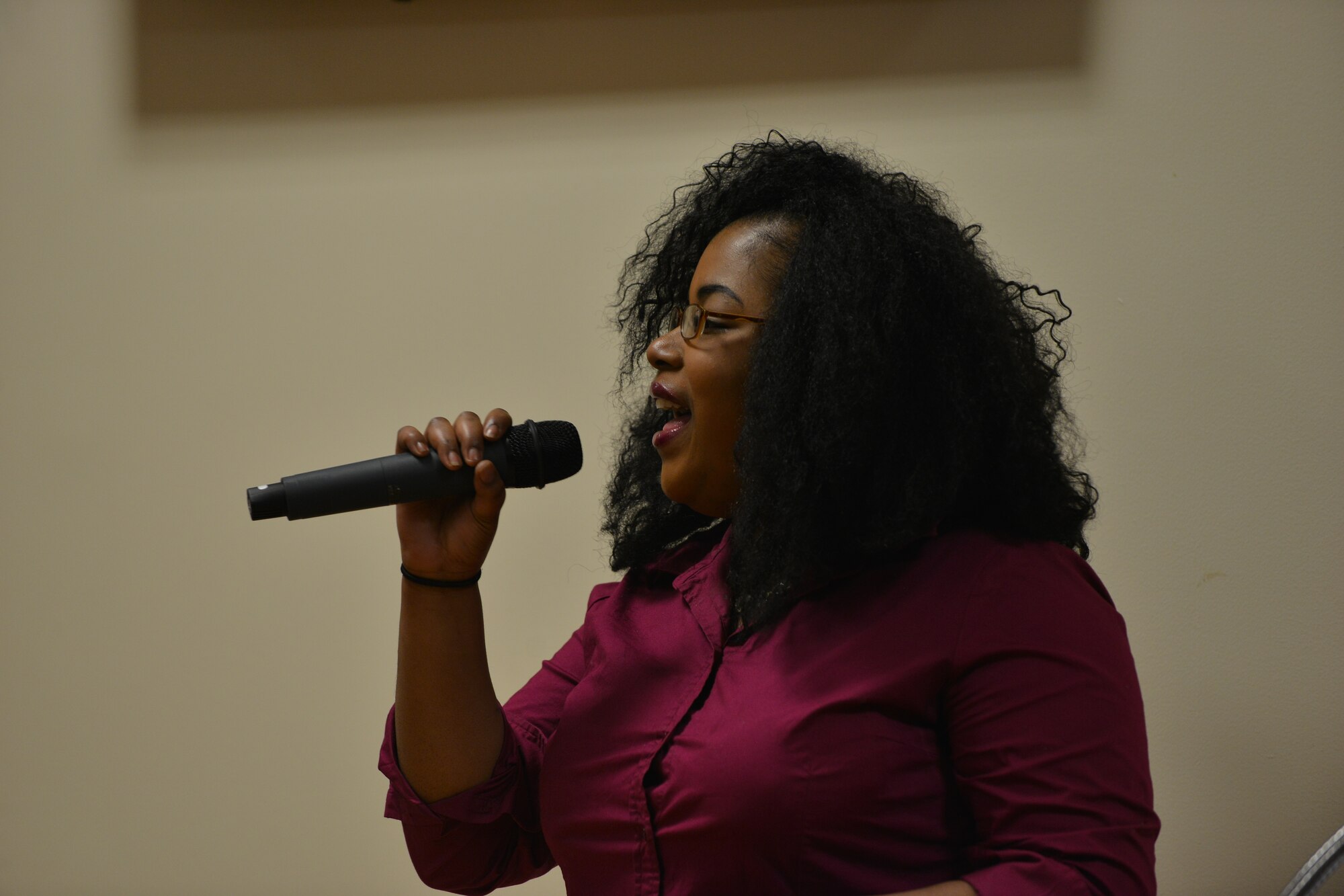 Charee Moore, a Gold Star family member, sings at the 5th Annual Survivor Outreach Services’ Thanks for Giving social at Fort Eustis, Va., Nov. 19, 2015. The Fort Eustis Gold Star program provides support to families of any U.S. Service who lost a military member while serving in any capacity. (U.S. Air Force photo by Staff Sgt. Natasha Stannard)