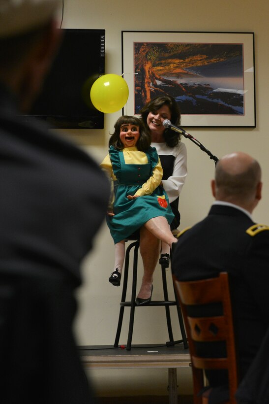 Sharon H. Dyess, a professional ventriloquist, entertains attendees at the 5th Annual Survivor Outreach Services’ Thanks for Giving social at Fort Eustis, Va., Nov. 19, 2015. Each year, the social hosts new and different acts to show appreciation for Gold Star family members. (U.S. Air Force photo by Staff Sgt. Natasha Stannard)