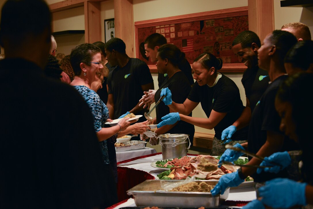 Members of the 93rd Signal Brigade Better Opportunities for Single Soldiers (BOSS) serve food at the 5th Annual Survivor Outreach Services’ Thanks for Giving social at Fort Eustis, Va., Nov. 19, 2015. The BOSS members served alongside Boy Scout, Girl Scout and Cub Scouts of America groups. (U.S. Air Force photo by Staff Sgt. Natasha Stannard)