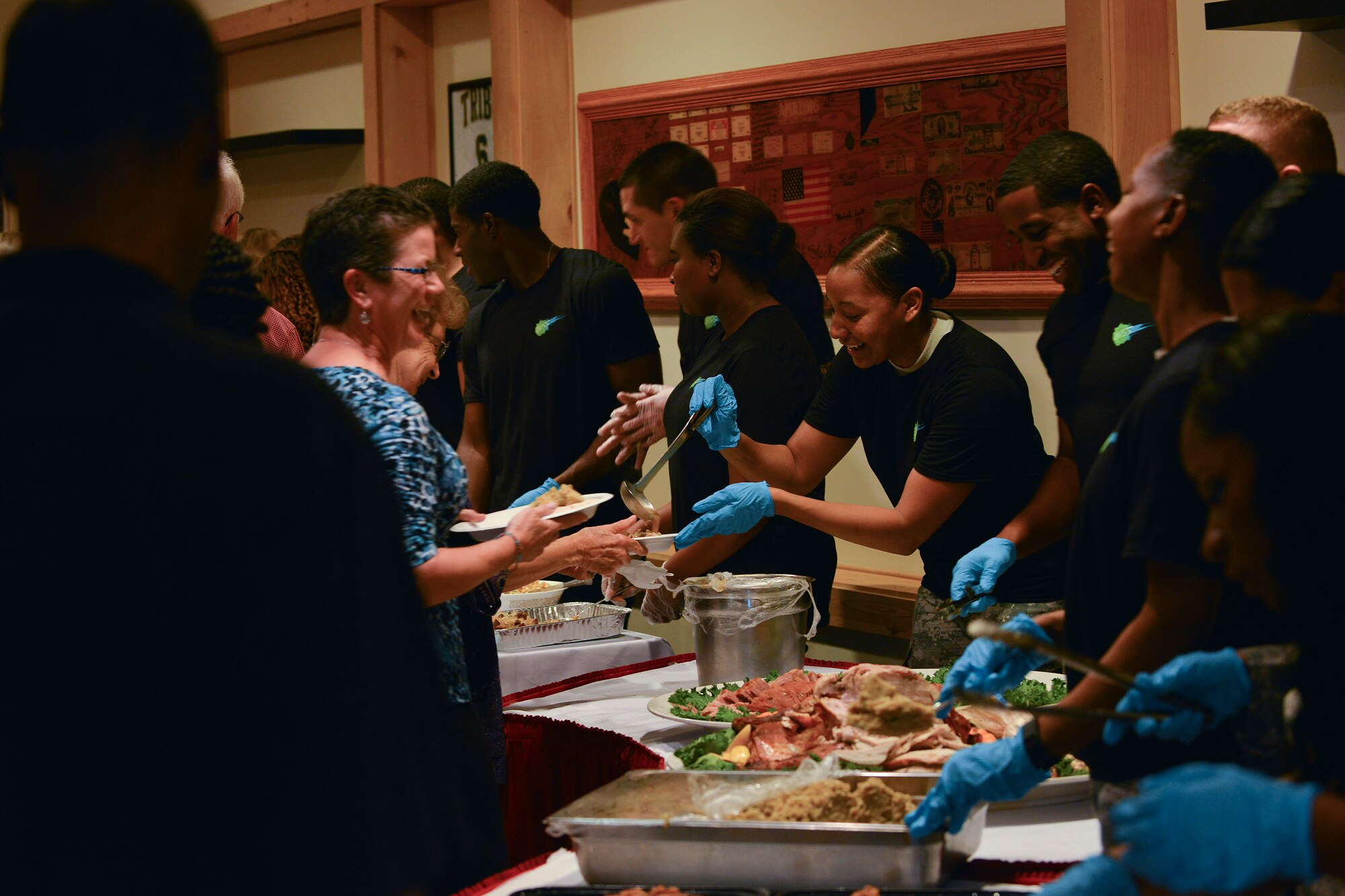 Members of the 93rd Signal Brigade Better Opportunities for Single Soldiers (BOSS) serve food at the 5th Annual Survivor Outreach Services’ Thanks for Giving social at Fort Eustis, Va., Nov. 19, 2015. The BOSS members served alongside Boy Scout, Girl Scout and Cub Scouts of America groups. (U.S. Air Force photo by Staff Sgt. Natasha Stannard)
