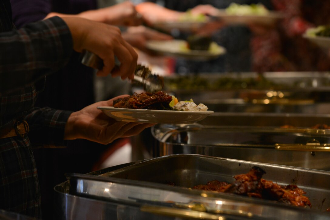 Fort Eustis’ Spouses Club (SCFE) members fill their plates with food during the club’s monthly luncheon at Fort Eustis, Va., Nov. 19, 2015. Along with the luncheon, the club hosts events throughout the year to provide support to U.S. Soldiers and their families. (U.S. Air Force photo by Staff Sgt. Natasha Stannard)