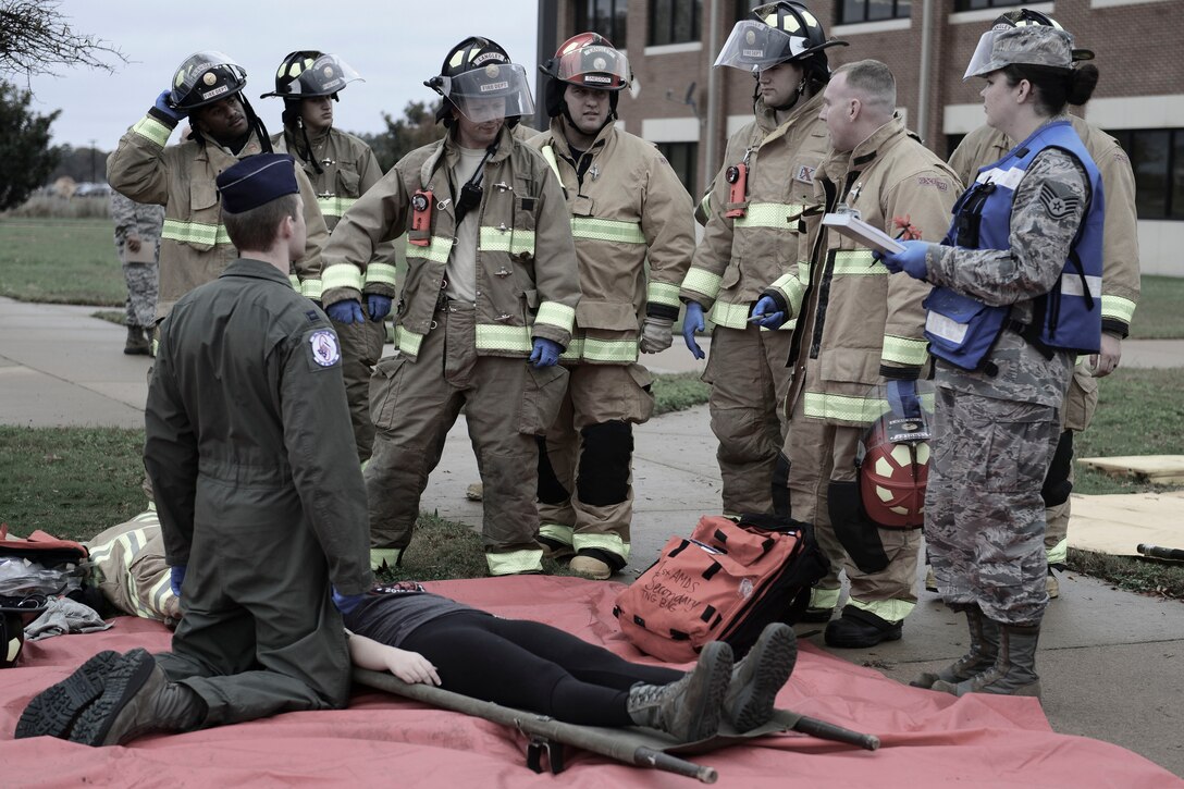Emergency responders discuss retrieving victims during an active shooter exercise at Langley Air Force Base, Va., Nov. 19, 2015. The exercise evaluated incident reporting processes, installation command notifications, and activation of appropriate command and control actions. (U.S. Air Force photo illustration by Staff Sgt. Ciara Gosier)