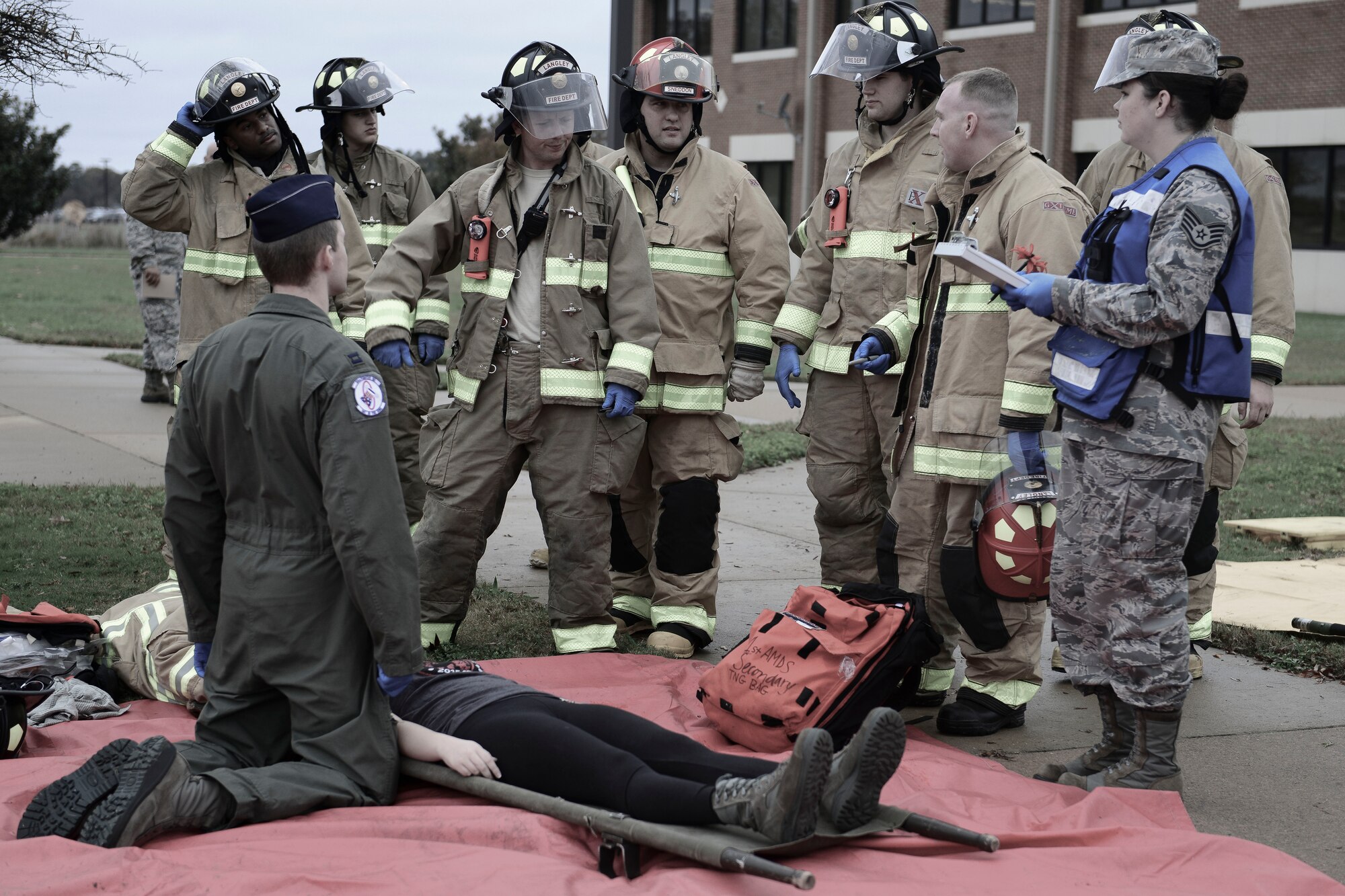 Emergency responders discuss retrieving victims during an active shooter exercise at Langley Air Force Base, Va., Nov. 19, 2015. The exercise evaluated incident reporting processes, installation command notifications, and activation of appropriate command and control actions. (U.S. Air Force photo illustration by Staff Sgt. Ciara Gosier)