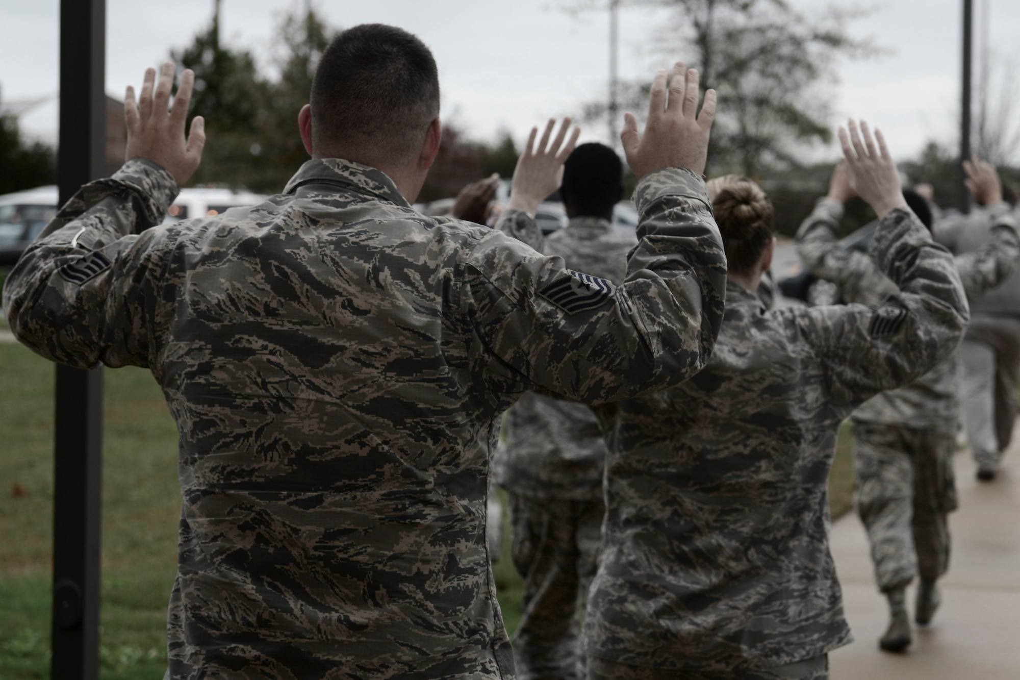 U.S. Airmen exit a building during an active shooter exercise at Langley Air Force Base, Va., Nov. 19, 2015. During the exercise, the shooter entered their building which alerted the building residents to execute lockdown procedures until security forces arrived to allow them to exit. (U.S. Air Force photo illustration by Staff Sgt. Ciara Gosier)