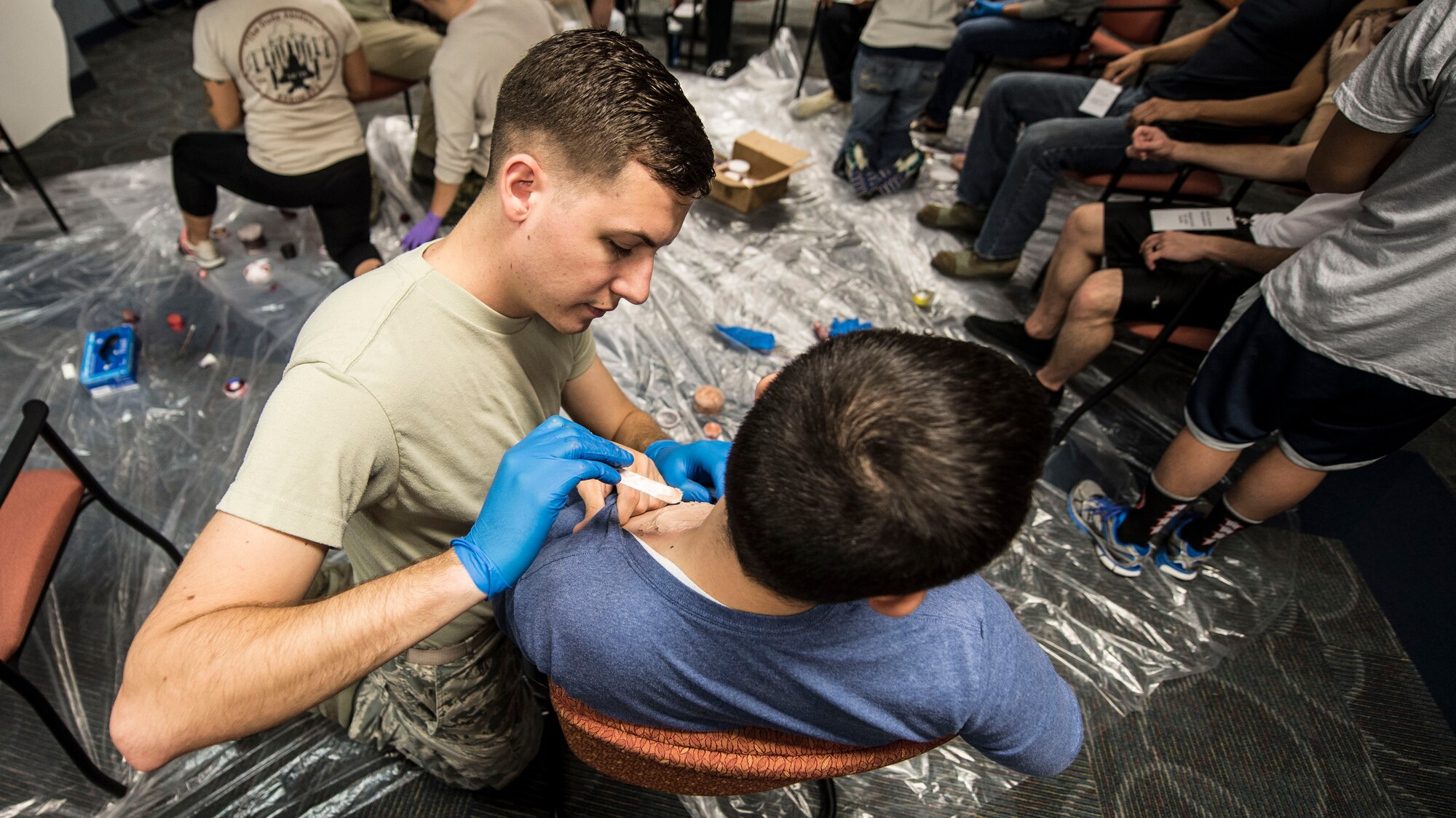 U.S. Airmen don medical mulage prior to an active shooter exercise at Langley Air Force Base, Va., Nov. 19, 2015. During the exercise, first responders were evaluated on their response to mass casualties. (U.S. Air Force photo by Senior Airman Kayla Newman)
