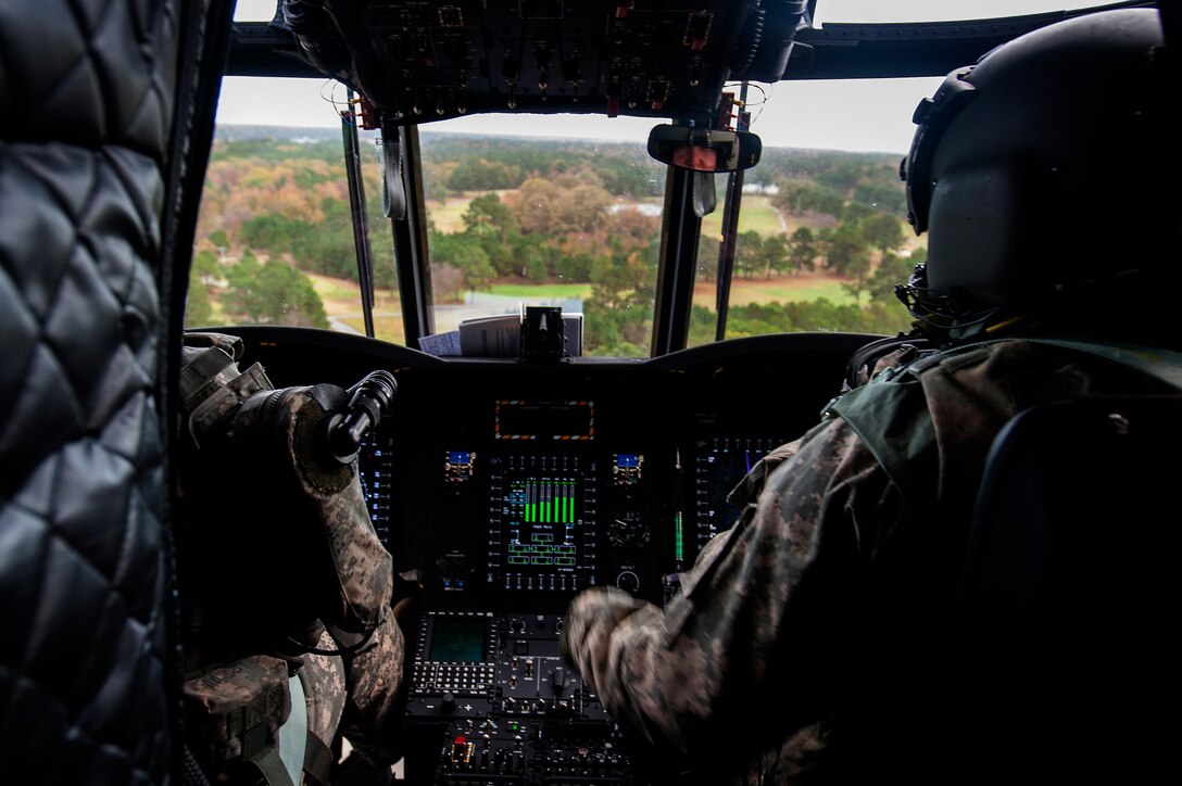 U.S. Army Chief Warrant Officer 4 Glenn Coffin, a pilot assigned to B Company, 5th Battalion (General Support) Aviation, 159th Aviation Regiment, flies a CH-47 Chinook during a training mission at Felker Army Air Field, Fort Eustis, Va., Nov. 18, 2015. As pilots and crew members in the Reserves, Coffin and his crew must retain the same flying hours as their active duty counterparts in order to maintain their certification. (U.S. Air Force photo by Senior Airman Breonna Veal) 