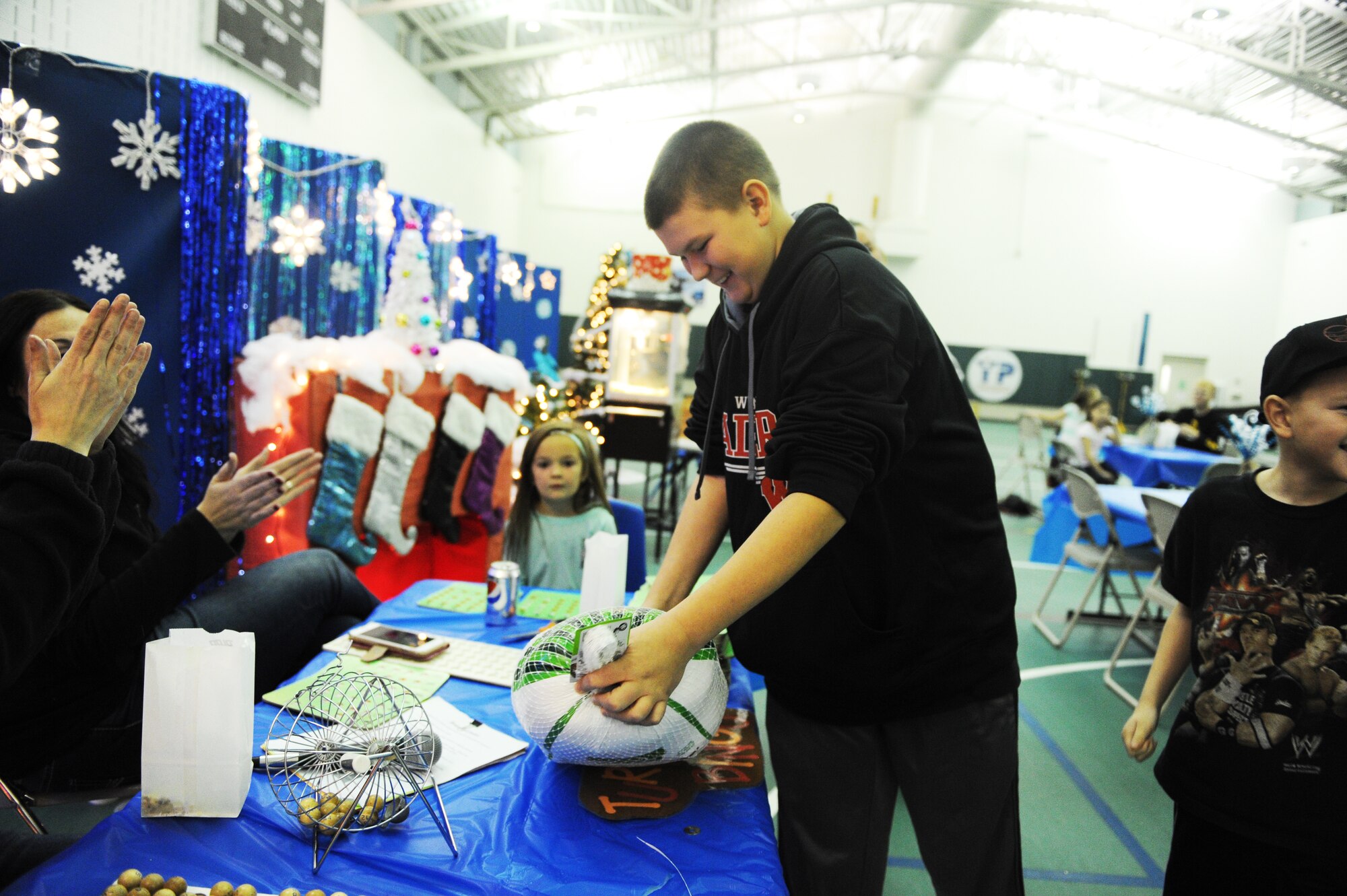 Member from the base youth center wins a turkey during the annual Turkey Bingo event at the youth center at Minot Air Force Base, N.D., Nov. 21, 2015. This was the 11th year the youth center has held the Turkey Bingo and is part of many events during the holiday season.(U.S. Air Force photo by Staff Sgt. Chad Trujillo)