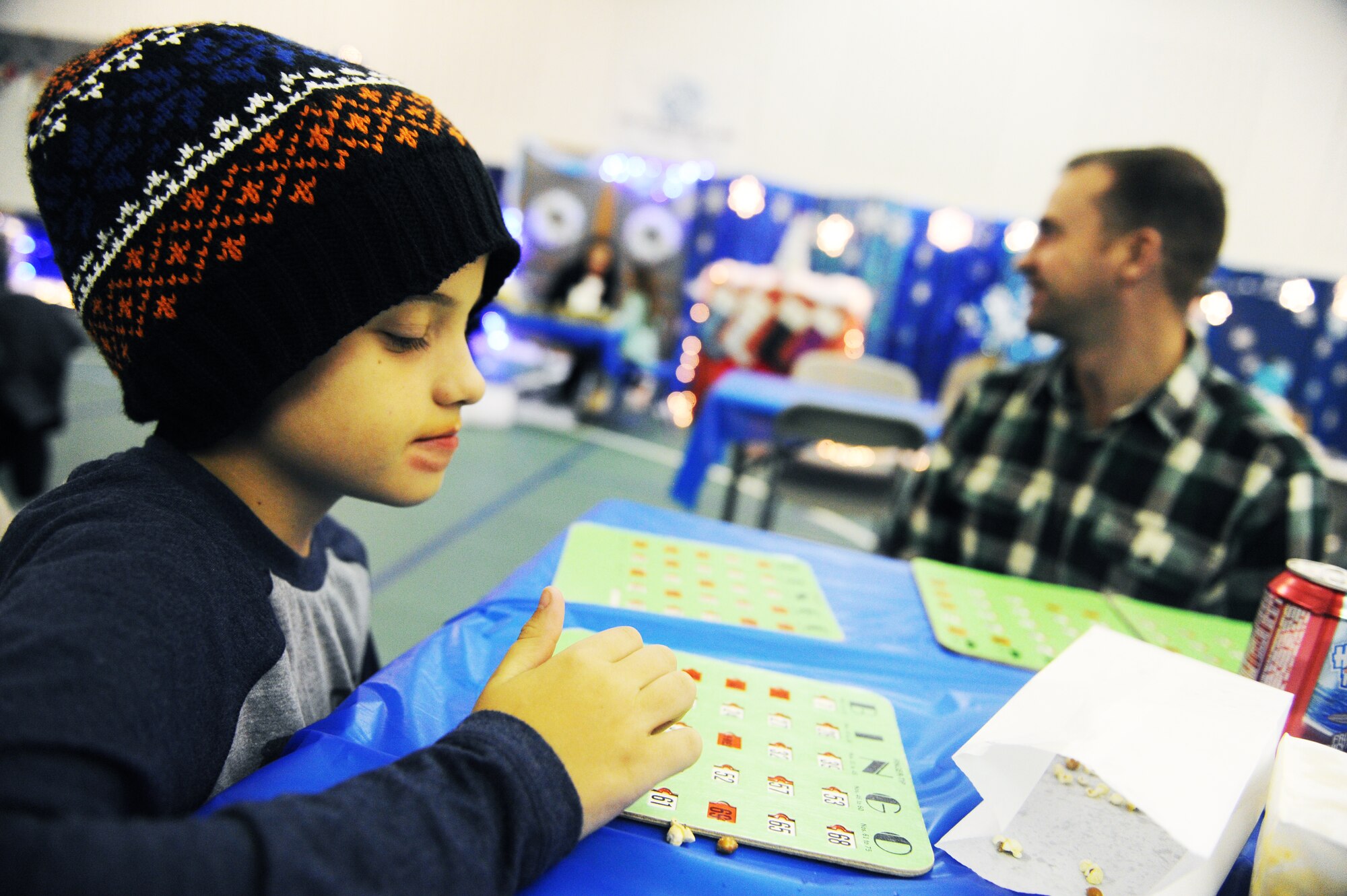 Tony Davidson plays bingo during the annual Turkey Bingo event at the youth center at Minot Air Force Base, N.D., Nov. 21, 2015. This was the 11th year the youth center has held the Turkey Bingo and is part of many events during the holiday season. (U.S. Air Force photo by Staff Sgt. Chad Trujillo)