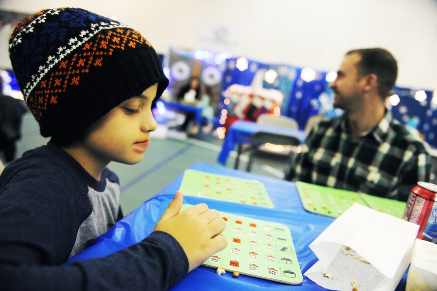 Tony Davidson plays bingo during the annual Turkey Bingo event at the youth center at Minot Air Force Base, N.D., Nov. 21, 2015. This was the 11th year the youth center has held the Turkey Bingo and is part of many events during the holiday season. (U.S. Air Force photo by Staff Sgt. Chad Trujillo)