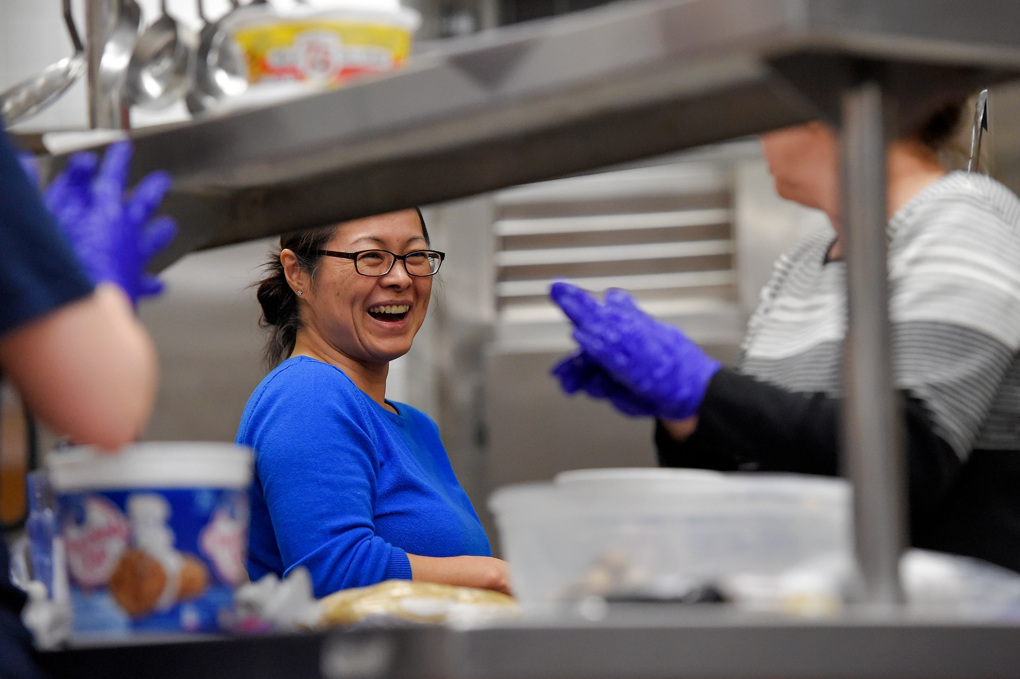 Volunteers bake thousands of cookies utilizing the Wolf's Den dining facility kitchen on Joint Base Elmendorf-Richardson, Alaska, Nov. 17, 2015. During the cookie drive volunteers collected dough, baked, sorted and packaged the cookies. The cookies will later be delivered to single Airmen and Soldiers living in the dorms and barracks to provide them with a homemade treat during the holiday season. (U.S. Air Force photo/Alejandro Peña)