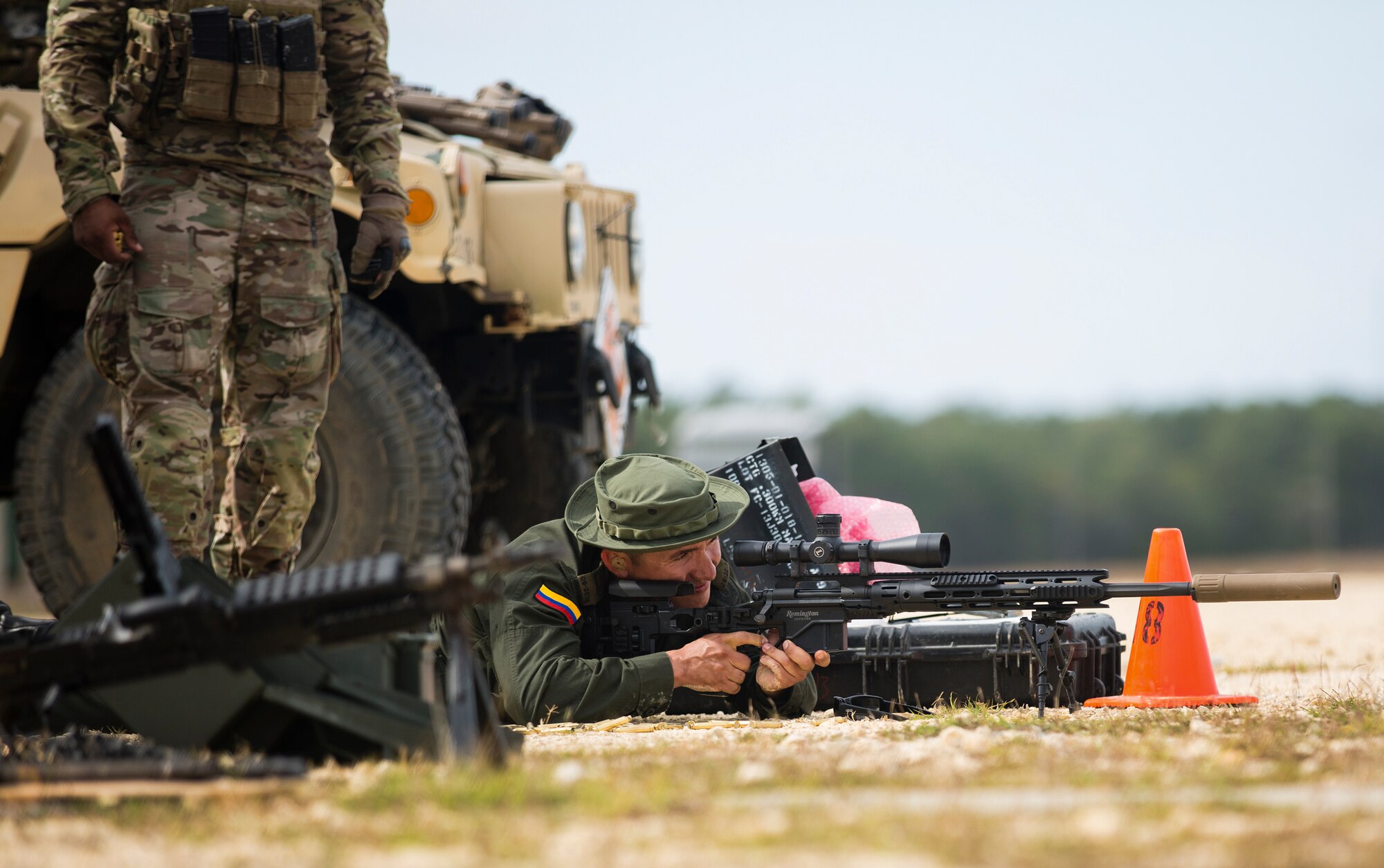 A member of the Colombian Compana Jungla Antinarcoticos aims a sniper rifle downrange during familiarization training conducted Nov. 17 on an Eglin Air Force Base Range.  The partnership training between the Colombian Junglas, as they are known, and the American Special Forces is a component of one of the Western Hemisphere’s most enduring security partnerships formed to counter narcotic and human trafficking. (U.S. Army photo/Staff Sgt. William Waller)