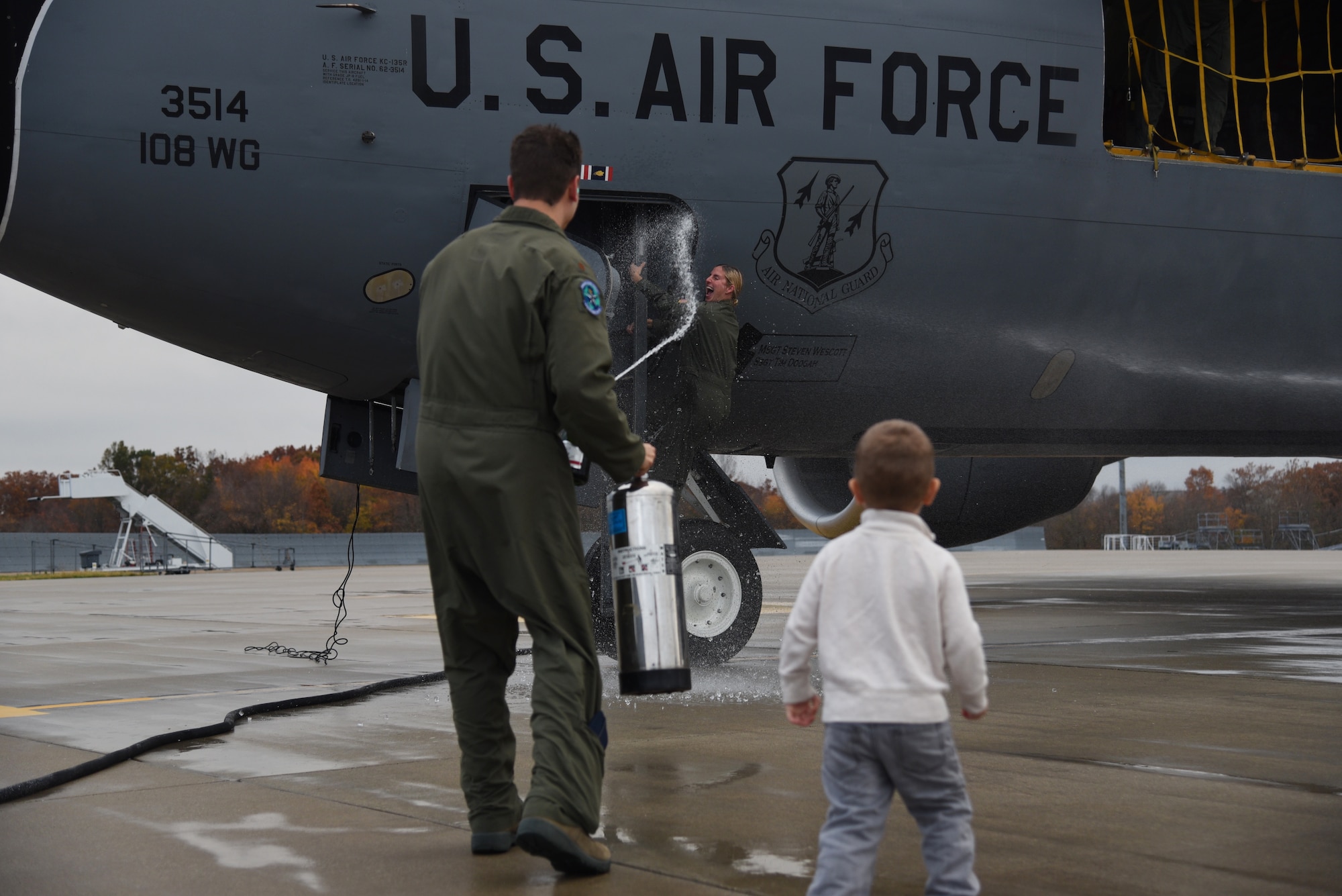 Capt. Sharon Gilliand, a KC-135 Stratotanker pilot with the 108th Wing, receives a celebratory spraying from her husband Maj. Kiel Gilliand, children Garrett and Lacey, fellow pilots and crew members following her final flight for the 108th Wing at Joint Base Mcguire-Dix-Lakehurst on Nov. 5, 2015. Gilliland, a pilot for 12 years with the New Jersey Air National Guard’s 108th Wing is ceremonially hosed down by fellow pilots, crewmembers, friends and family as she leaves piloting to others and takes a non-flying job with the 514th AMOS, Air Force Reserve so she can devote more time to her family. During her time in the 108th Wing, Gilliland deployed three times and has 60 combat sorties to her credit. (U.S. Air National Guard photo by Master Sgt. Carl Clegg/Released)