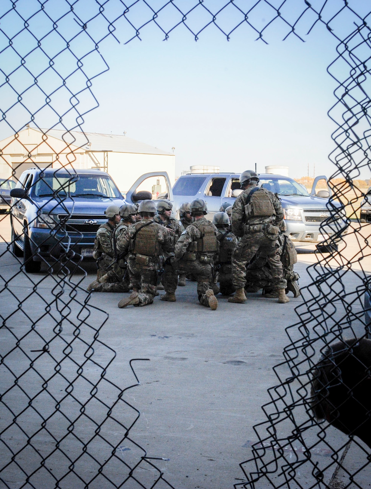 791st Missile Security Forces Squadron tactical response force members take a knee after completing an exercise at Minot Air Force Base, N.D., Oct. 14, 2015. TRF specializes in close quarters battle where the objective is to neutralize enemies, clear the building and secure any assets. (U.S. Air Force photo/Airman 1st Class Sahara L. Fales)