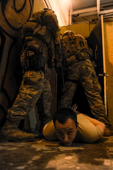 791st Missile Security Forces Squadron tactical response force members clear a room after taking down a simulated aggressor at Minot Air Force Base, N.D., Oct. 14, 2015. The mission of TRF is to respond to hostile attacks anywhere they occur within the 91st Missile Wing ICBM complex and to use all means necessary to defeat the adversary. (U.S. Air Force photo/Airman 1st Class Sahara L. Fales)
