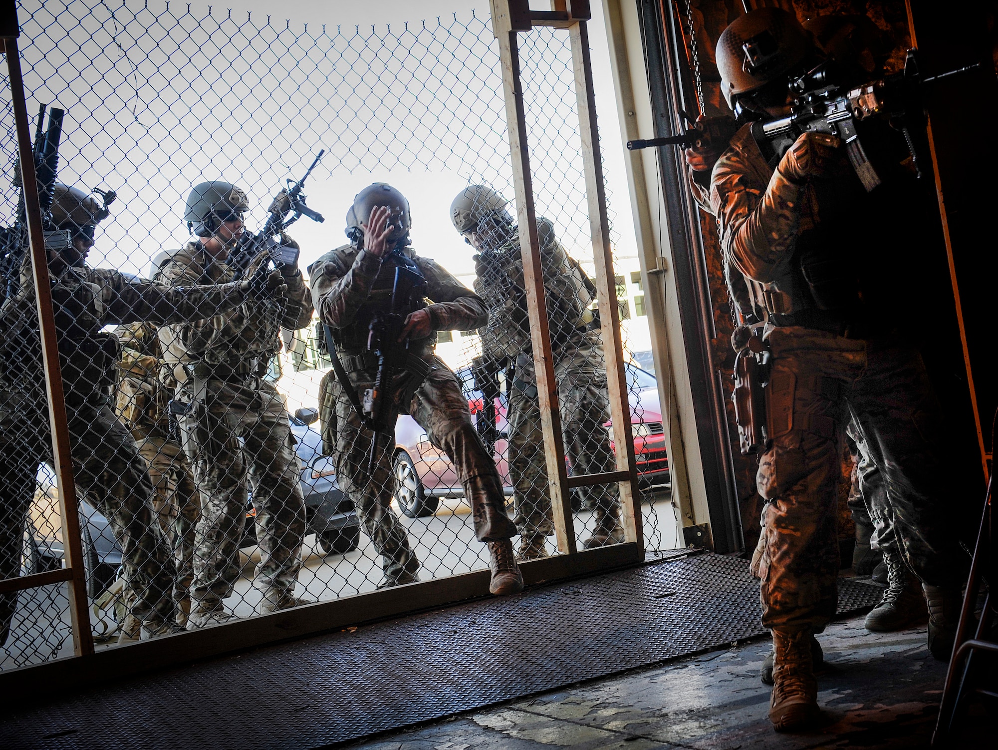791st Missile Security Forces Squadron tactical response force members enter a facility at Minot Air Force Base, N.D., Oct. 14, 2015. Upon reaching the compound, breachers are responsible for using tools such as the K12 saw to allow for access. (U.S. Air Force photo/Airman 1st Class Sahara L. Fales)