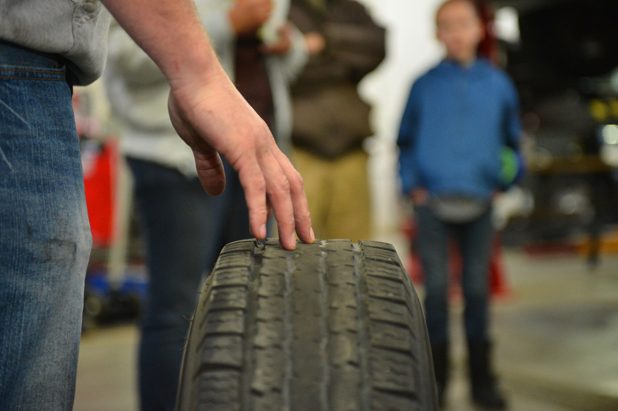 Tech. Sgt. Andrew Wanzer, 460th Logistics Readiness Squadron NCO in charge of logistics plans, explains how to properly maintain car tires as part of his Automotive 101 class Nov. 21, 2015, on Buckley Air Force Base, Colo. The class teaches basic skills to safely maintain a motor vehicle and is set to take place once a month. (U.S. Air Force photo by Staff Sgt. Darren Scott/Released)