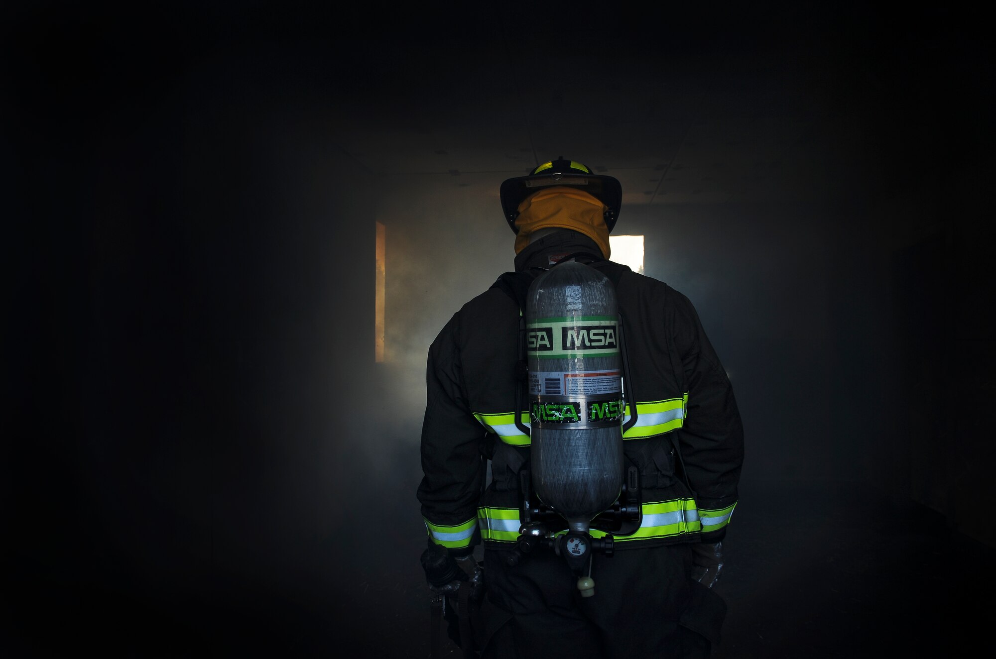 A Little Rock Air Force Base firefighter, walks toward burning debris during live fire exercises Mar. 27, 2013, at Little Rock Air Force Base, Ark. The Little Rock AFB Fire Dept. is now one of three accredited fire departments in Arkansas. (U.S. Air Force photo by Senior Airman Scott Poe)