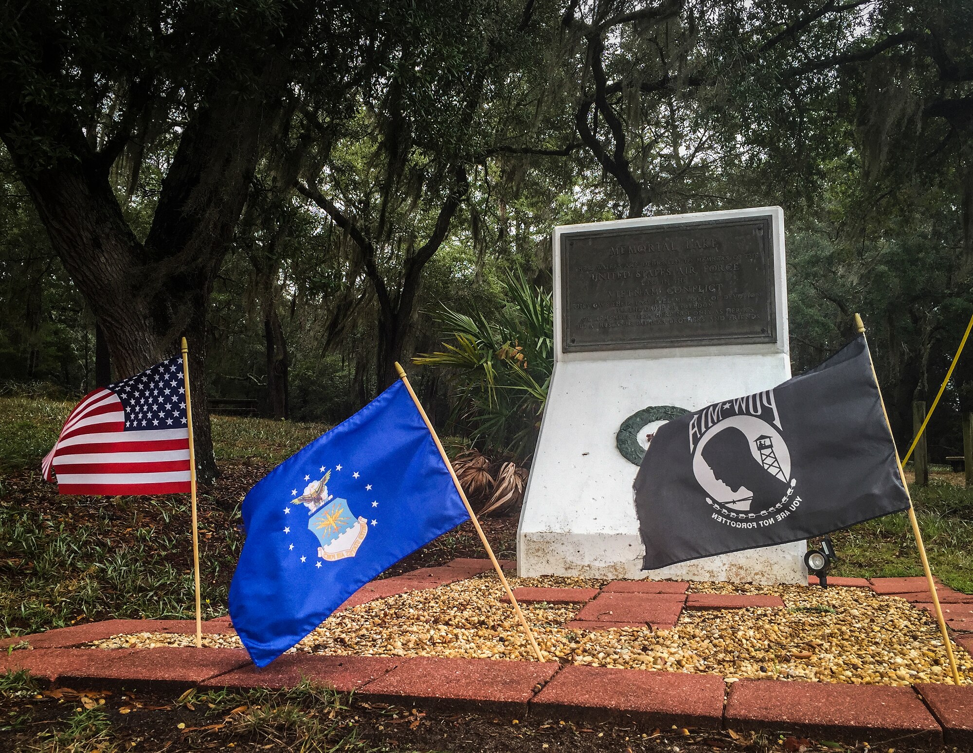 Flags blow in the wind in front of a little-known monument Nov. 18 at Eglin Air Force Base, Fla.  The monument, located just behind the satellite pharmacy and Class-Six, is for Memorial Lake and is dedicated to the Airmen lost in the Vietnam conflict.  (U.S. Air Force photo/Samuel King Jr.)