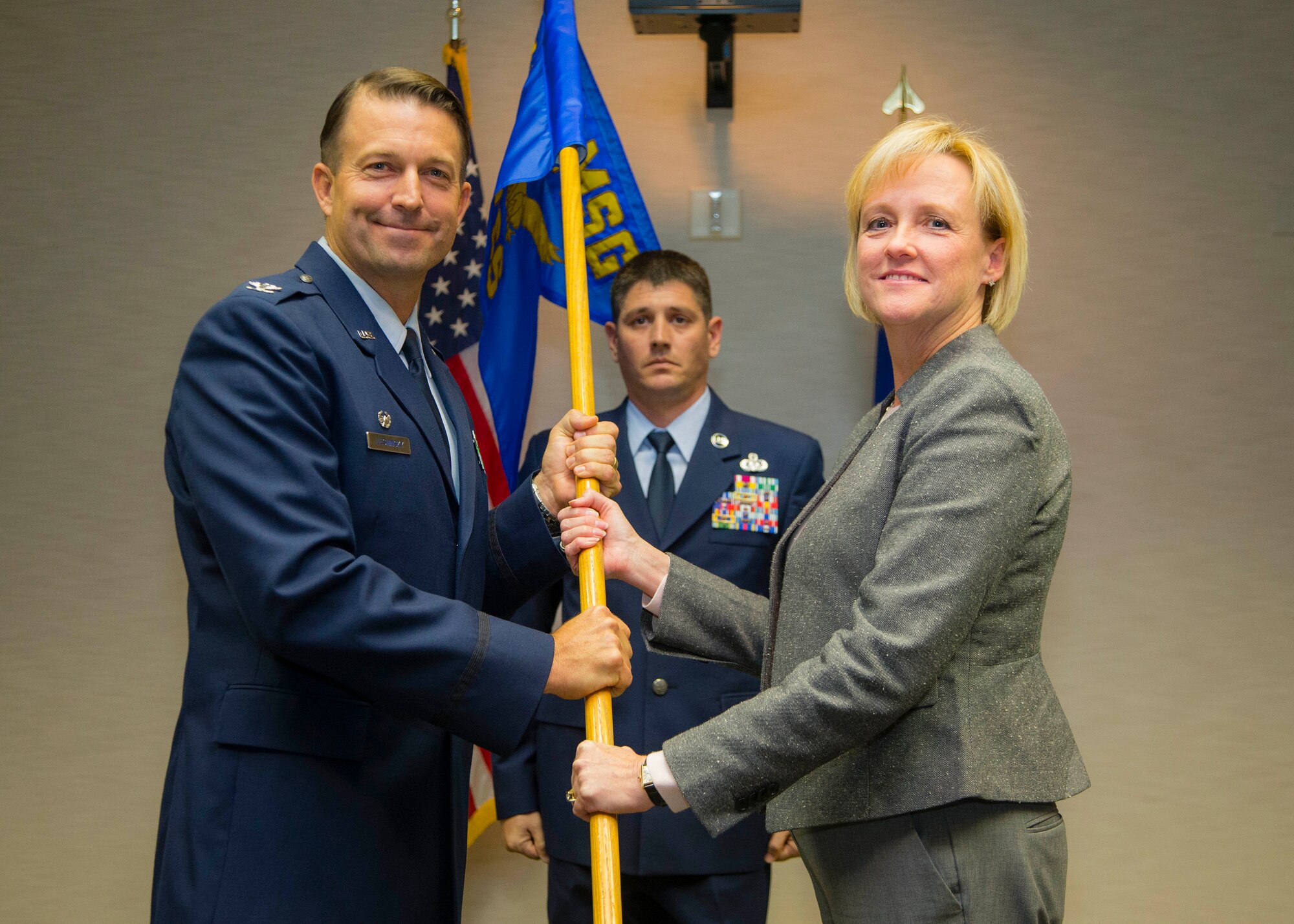 Col. Eric Leshinsky, 412th Mission Support Group commander, and Janice L. Hollen pose for a photo with the 412th Force Support Squadron guidon. Hollen will serve as the new director of the squadron. The assumption of leadership ceremony was held at Club Muroc Nov. 20. (U.S. Air Force photo by Christopher Okula)