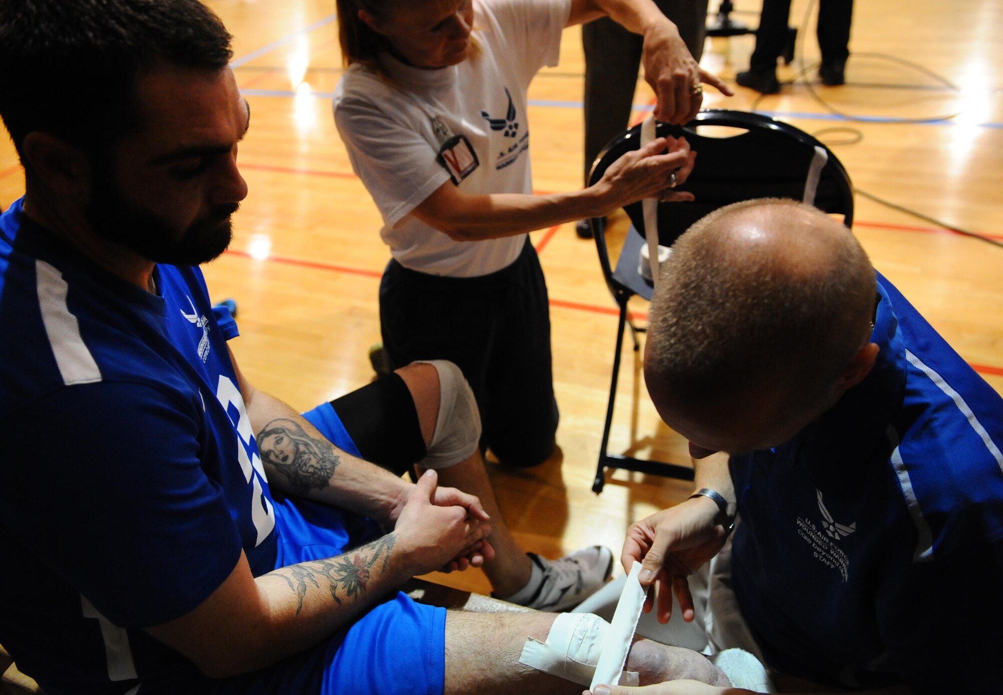 Retired Staff Sgt. Nicholas Dadgostar gets his leg taped after the Warrior Care Month Sitting Volleyball Tournament championship game at the Pentagon in Washington, D.C., Nov. 19, 2015. The Air Force won the tournament by beating the Marines. (U.S. Air Force photo/Senior Airman Hailey Haux)