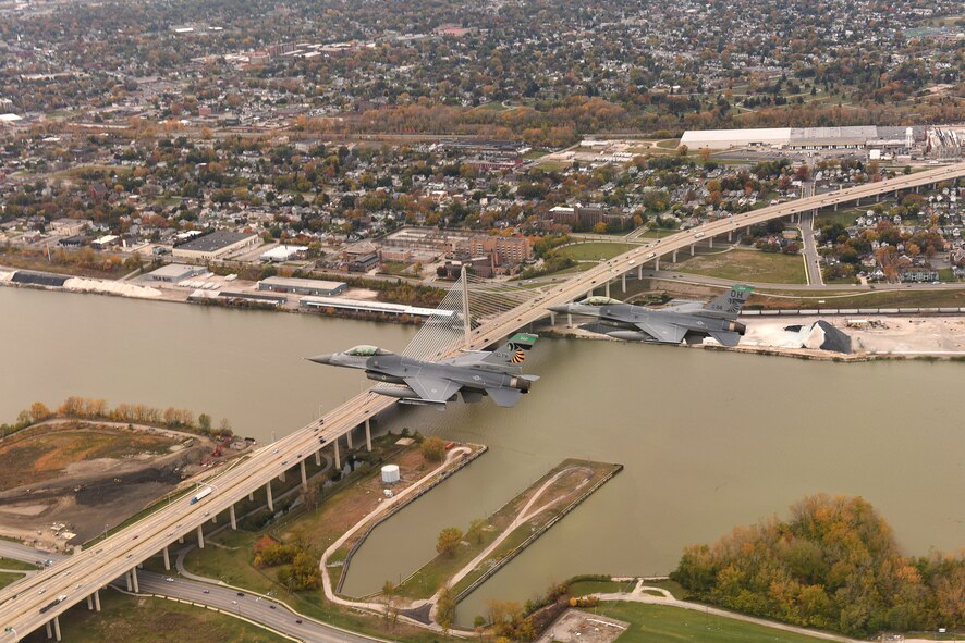 F-16 Fighting Falcons from the 180th Fighter Wing, Ohio Air National Guard, conduct a routine training mission over the Veterans Glass City Skyway in Toledo, Ohio, Oct. 24, 2015. The 180th FW performs daily training, conducted in realistic environments under realistic circumstances, to ensure our forces maintain the highest levels of proficiency and readiness to defend our nation as the most lethal, innovative and efficient Fighter Wing in the Total Force, both at home and abroad.
