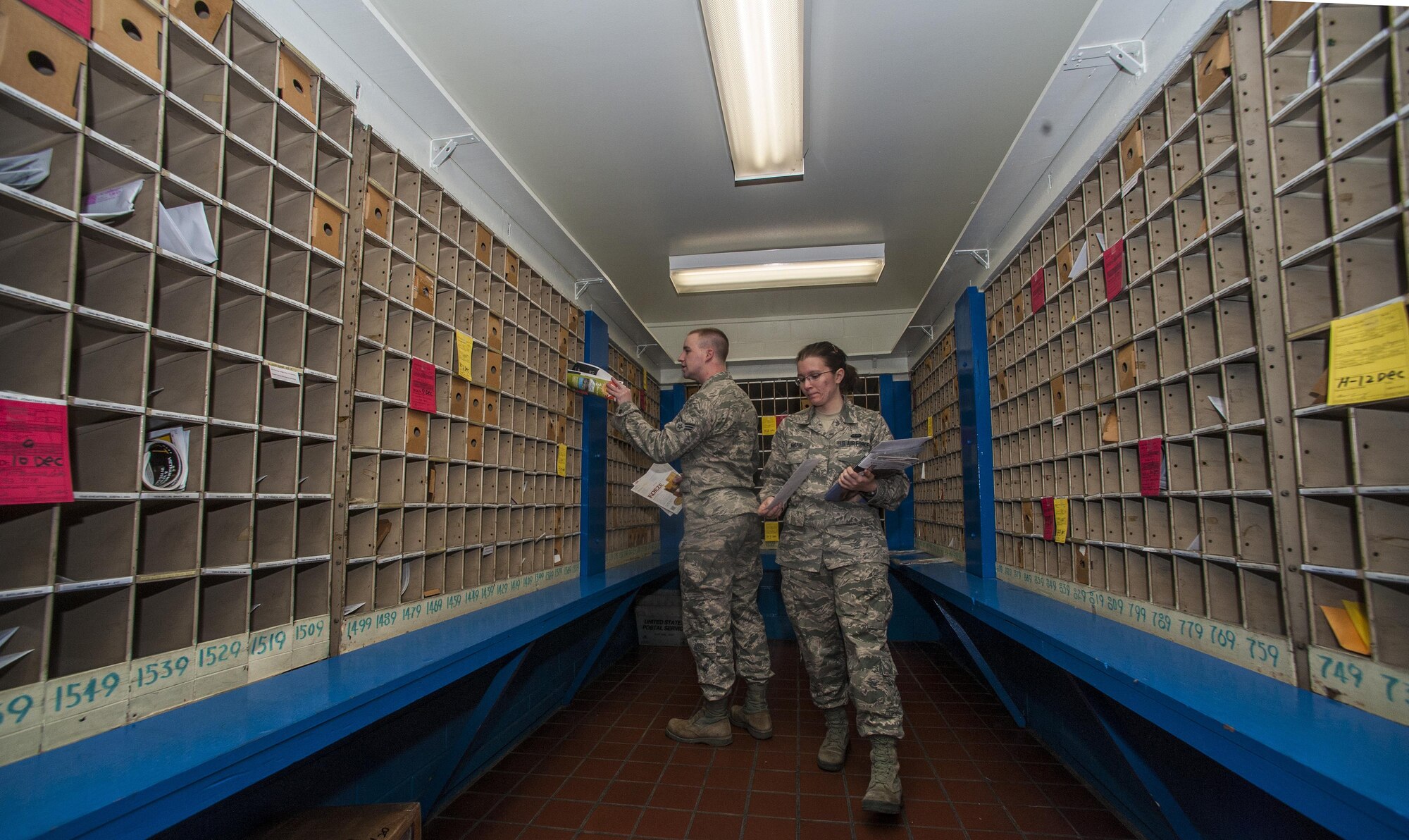 Senior Airman Cory Kittman and Airman 1st Class Mastin Alexandria, both post office volunteers from the 8th Communications Squadron, organize mail at the post office at Kunsan Air Base, Republic of Korea, Nov. 24, 2015. To accommodate service members during the holiday season, the post office is extending their hours to 9:30 a.m. to 5:30 p.m. on Monday – Friday and 10 a.m. to 2 p.m. on Saturdays from Nov. 23 to Jan. 2. (U.S. Air Force courtesy photo/Released)