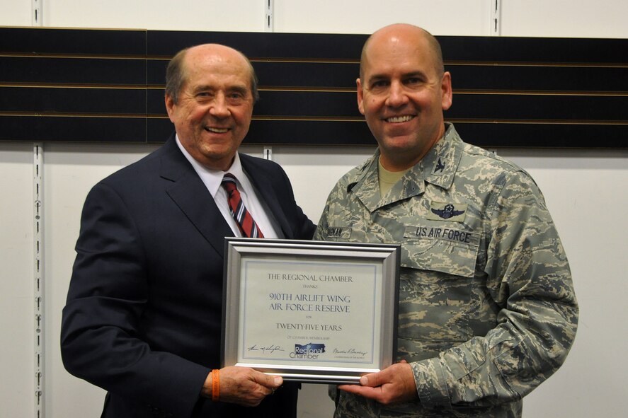 Col. James Dignan, commander of the 910th Airlift Wing based at nearby Youngstown Air Reserve Station, Ohio, accepts a certificate from Tom Humphries, President and Chief Executive Officer of the Youngstown-Warren Regional Chamber, at the organization’s board of directors meeting held at the Eastwood Mall here, Nov. 19, 2015. The certificate recognizes the 910th, the fourth largest employer in the Mahoning Valley with 1841 employees, for 25 years of membership with the chamber. The Youngstown-Warren Regional Chamber is the third largest chamber of commerce in Ohio and the 910th Airlift Wing is home base to eight C-130H Hercules aircraft tasked to carry out airlift/ airdrop missions in tactical environments as well as the Department of Defense’s only large-area, fixed wing aerial spray capability. (U.S. Air Force photo/Master Sgt. Bob Barko Jr.)
