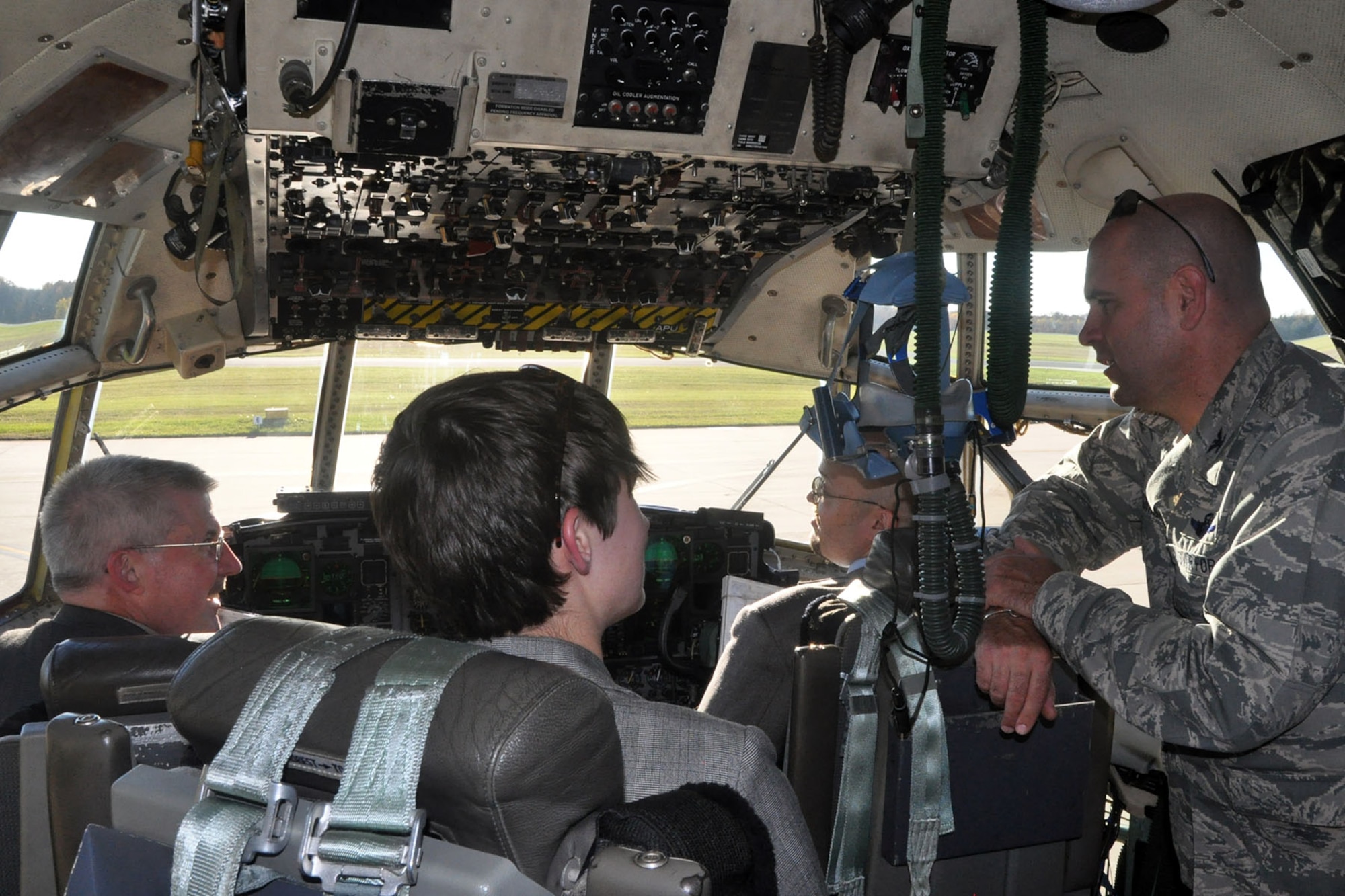 Col. James Dignan (far right), commander of the 910th Airlift Wing, talks to staffers from the office of Ohio U.S. Senator Sherrod Brown on the flight deck of a 910th C-130 Hercules tactical aircraft during a visit here, Nov. 3, 2015. The staffers for the Buckeye state’s senior senator are John Ryan (right), State Director; Sarah Lowry (center), Northeast Ohio Regional Representative; and Kenneth Williamson (second from left), Constituent Advocate; were at YARS for a tour of the installation including a walkthrough of the C-130 and a visit to the site of a proposed $9.4 million state of the art firing range. The funds for the new facility are included in the 2016 National Defense Authorization Act which was recently passed by the U.S. Congress and is currently awaiting President Obama’s approval. (U.S. Air Force photo/Master Sgt. Bob Barko Jr.)