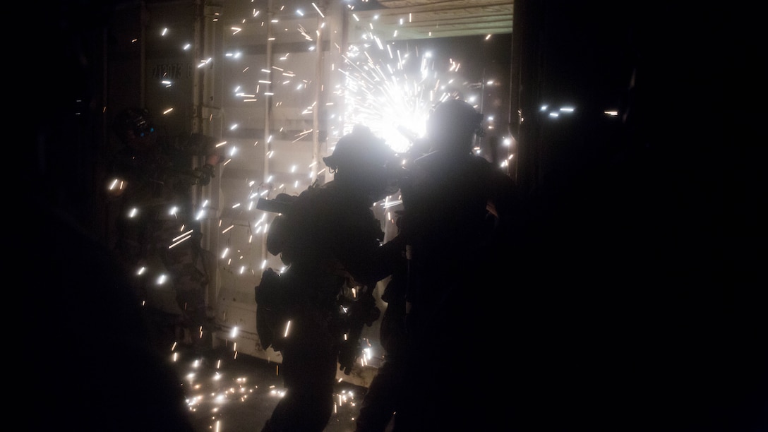 A Marine Raiders with Marine Special Operations Company  Charlie, 1st Marine Raider Battalion, U.S. Marine Corps Forces, Special Operations Command, breach a conex box with a saw during Visit, Board, Search and Seizure training, as part of a Company Collective Exercise, Oct. 15, 2015, in San Diego, California.
