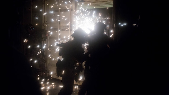 A Marine Raiders with Marine Special Operations Company  Charlie, 1st Marine Raider Battalion, U.S. Marine Corps Forces, Special Operations Command, breach a conex box with a saw during Visit, Board, Search and Seizure training, as part of a Company Collective Exercise, Oct. 15, 2015, in San Diego, California.