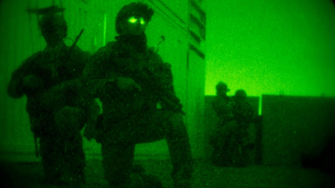 Marine Raiders with Marine Special Operations Company Charlie, 1st Marine Raider Battalion, U.S. Marine Corps Forces, Special Operations Command, set up a cordon around the perimeter of a building, while conducting a notional direct-action night raid, during a Company Collective Exercise, Oct. 17, 2015, in Florence, Arizona.