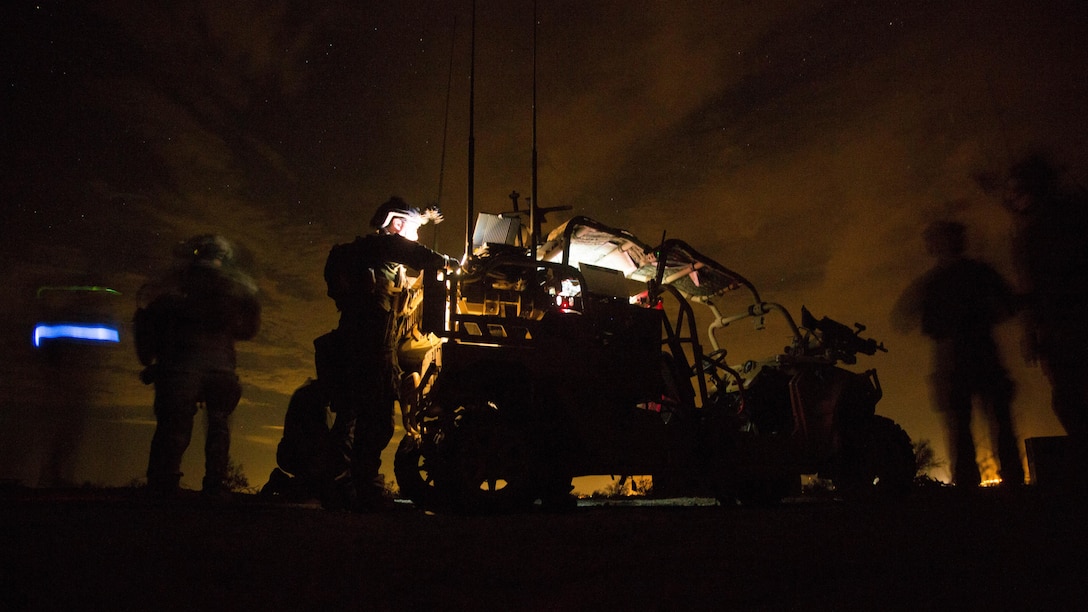 Marine Raiders with Marine Special Operations Company Charlie, 1st Marine Raider Battalion, U.S. Marine Corps Forces, Special Operations Command, process intelligence and set up a visual tele-communication feed after a notional direct-action night raid, a part of a Company Collective Exercise, Oct. 20, 2015, along the Arizona-California state line.