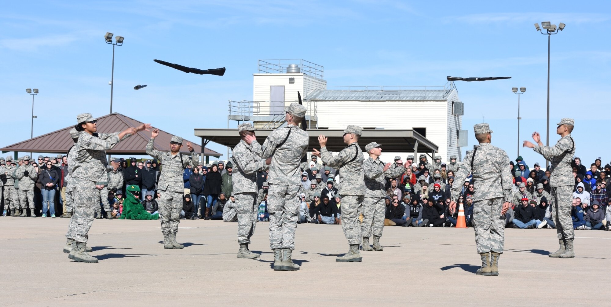 Members of the 316th Training Squadron black rope drill team perform an exhibition drill during a 17th Training Group drill competition for the 7th Annual Goodfellow Community Appreciation Day at the fire training pad on Goodfellow Air Force Base, Texas, Nov. 21, 2015. The 17th TRG hosts drill competitions quarterly and aligns the 4th quarter drill competition to highlight the group during the appreciation day. (U.S. Air Force photo by Staff Sgt. Laura R. McFarlane/Released) 