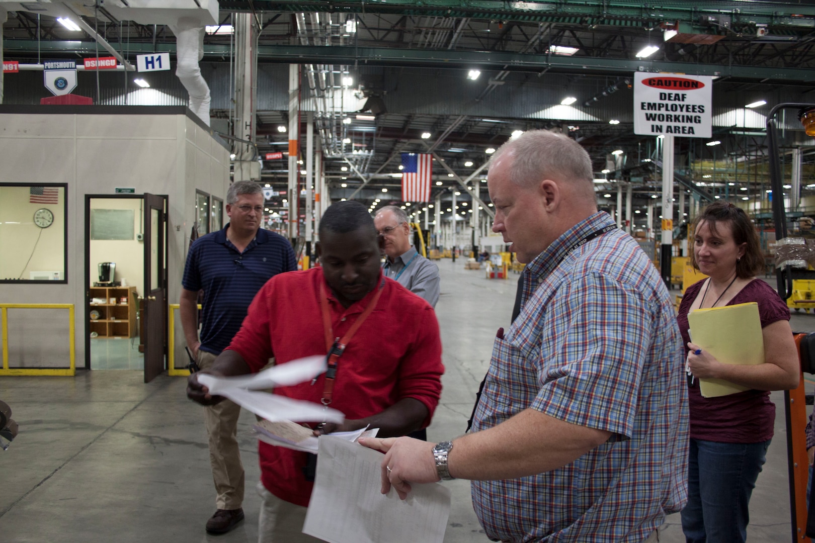 Joseph McCarthy, Defense Distribution Susquehanna supply technician hand delivers a rush order to Defense Distribution Susquehanna employee, Shawn Thomas for processing and shipping during the Nov. 6 ESOC COOP exercise.